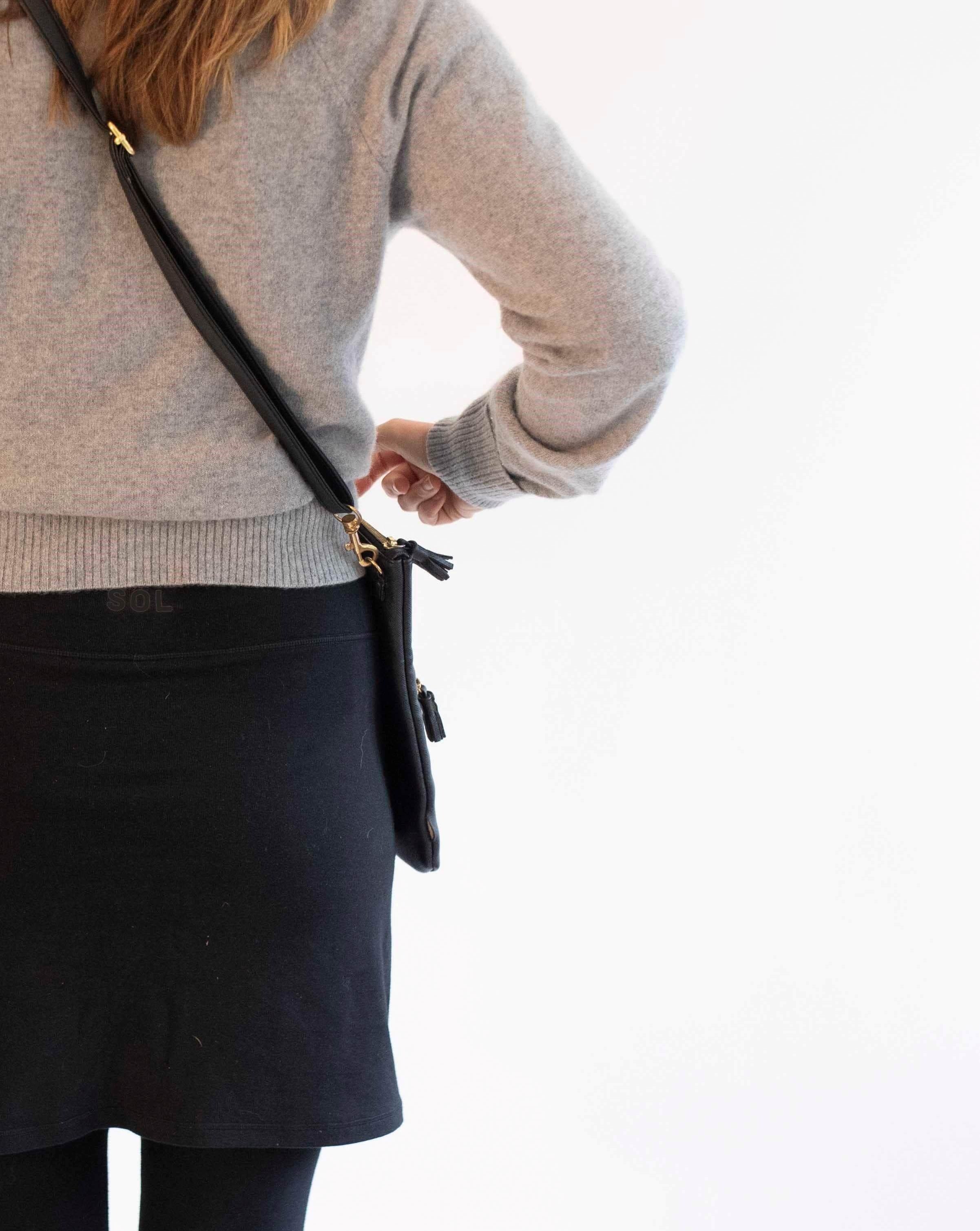 Woman wearing black skirted leggings with 17 inch skirt and cashmere grey turtlneck.-