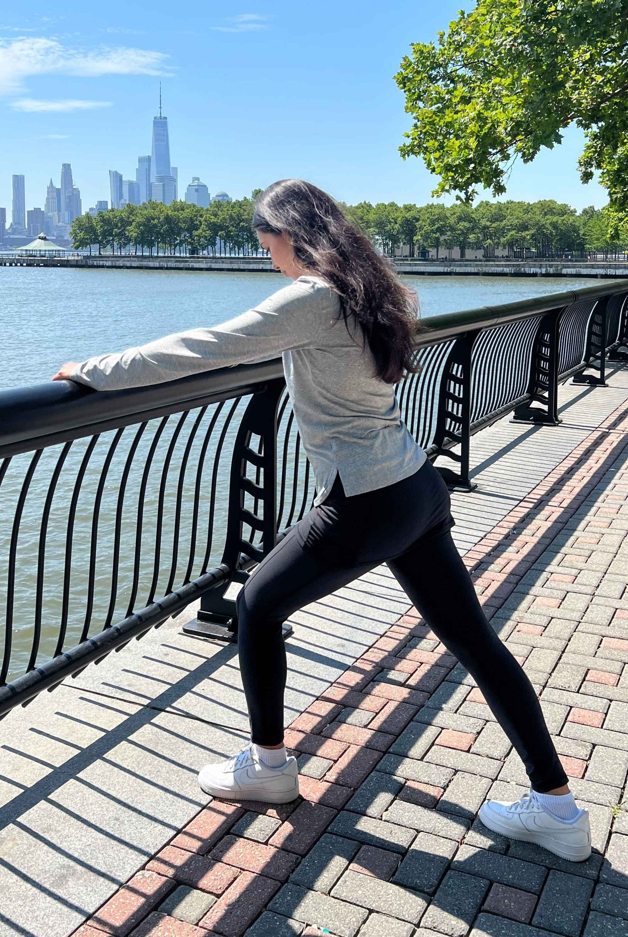 Black ankle length skirted leggings modeled by woman