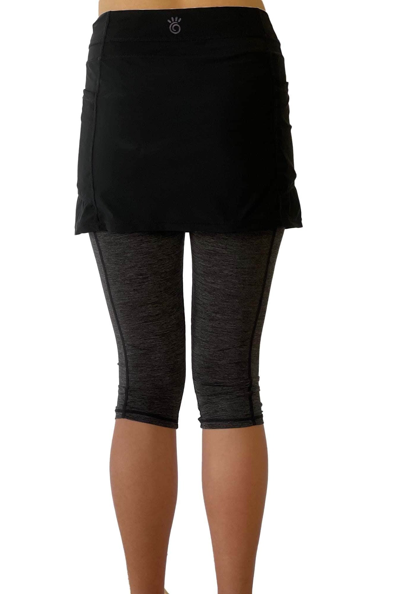 One piece black skirt with heather grey capris length leggings. Photo shows waist down shot of model wearing them from the back.