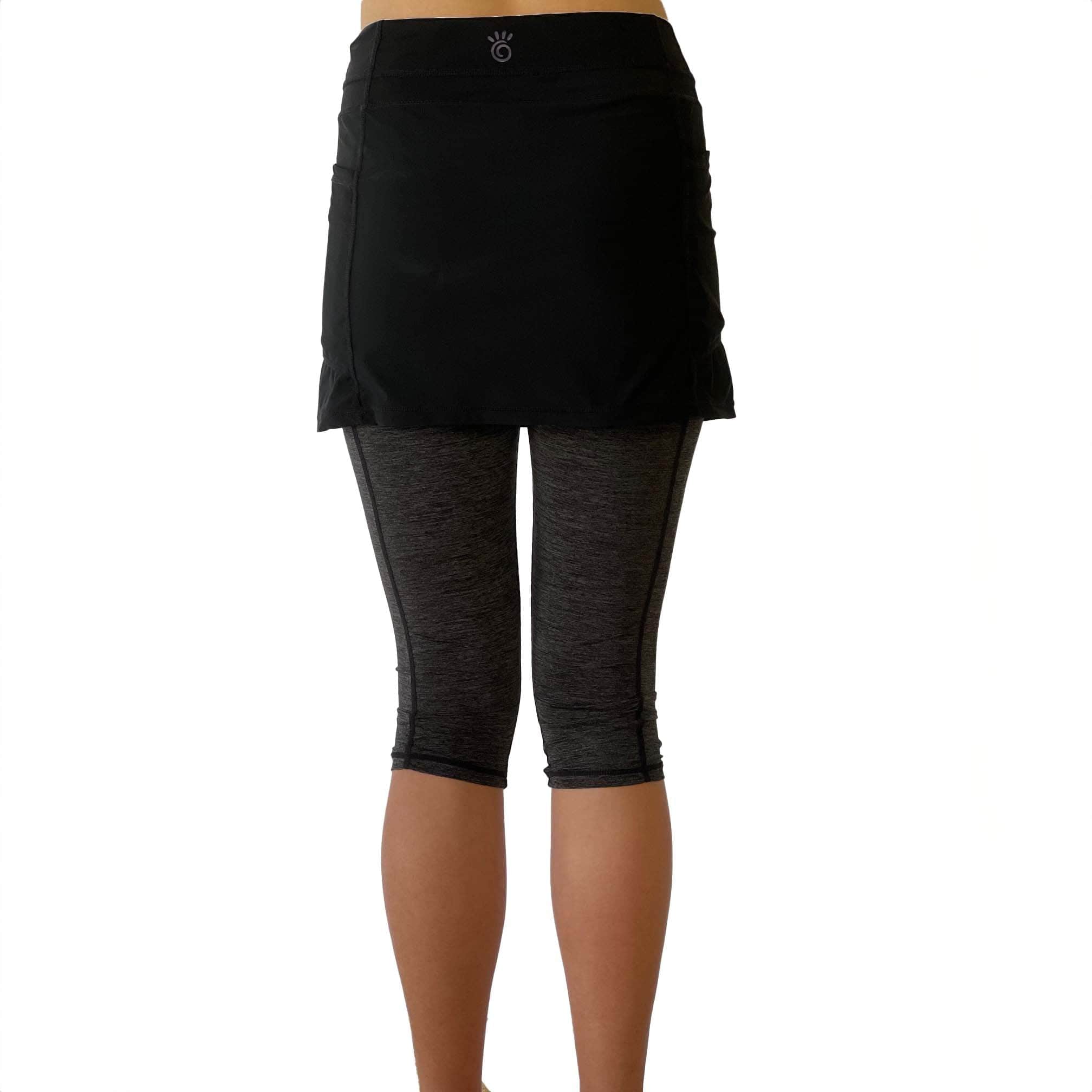 One piece black skirt with heather grey capris length leggings. Photo shows waist down shot of model wearing them from the back.