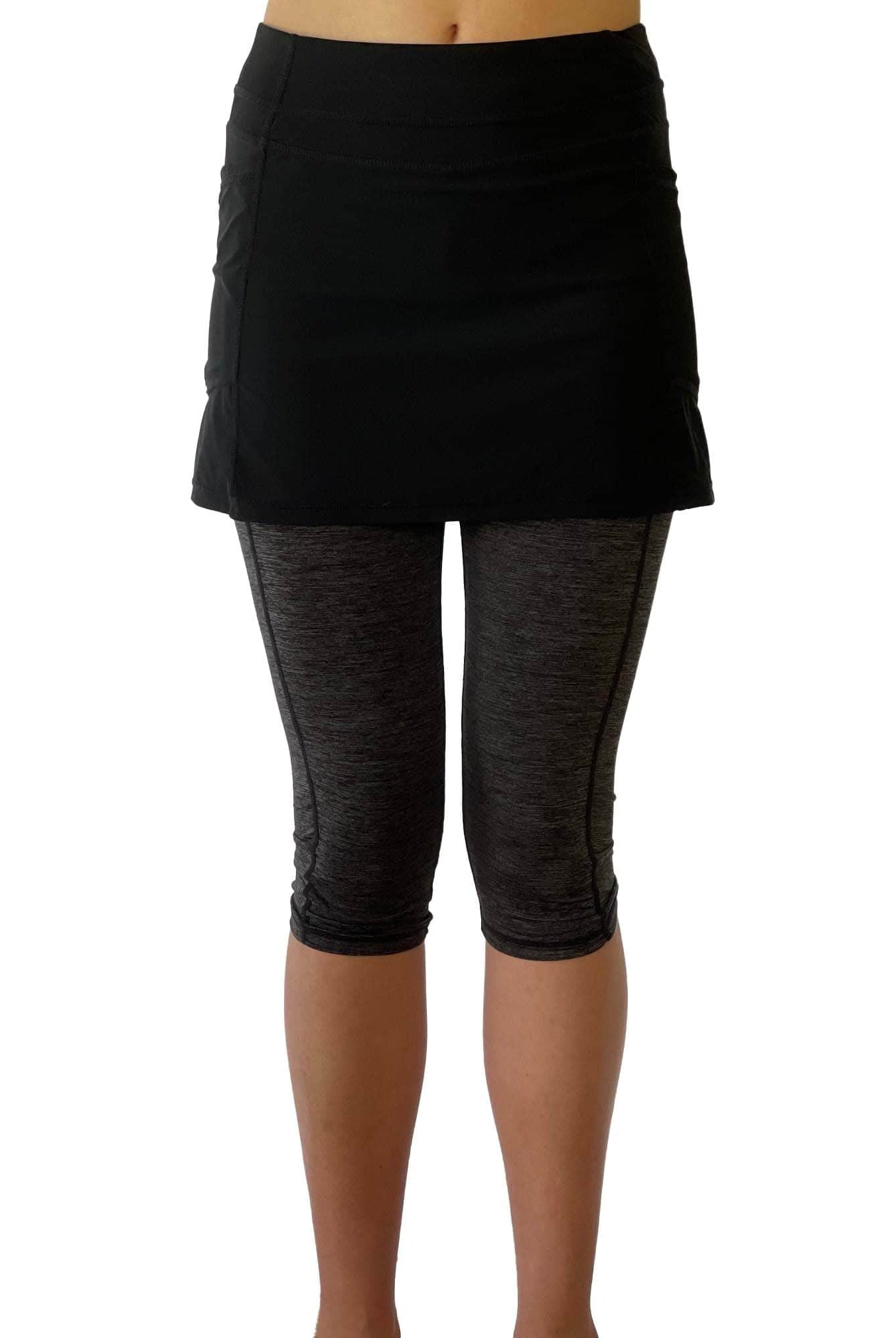 One piece black skirt with heather grey capris length leggings. Photo shows waist down shot of model wearing them from the front.