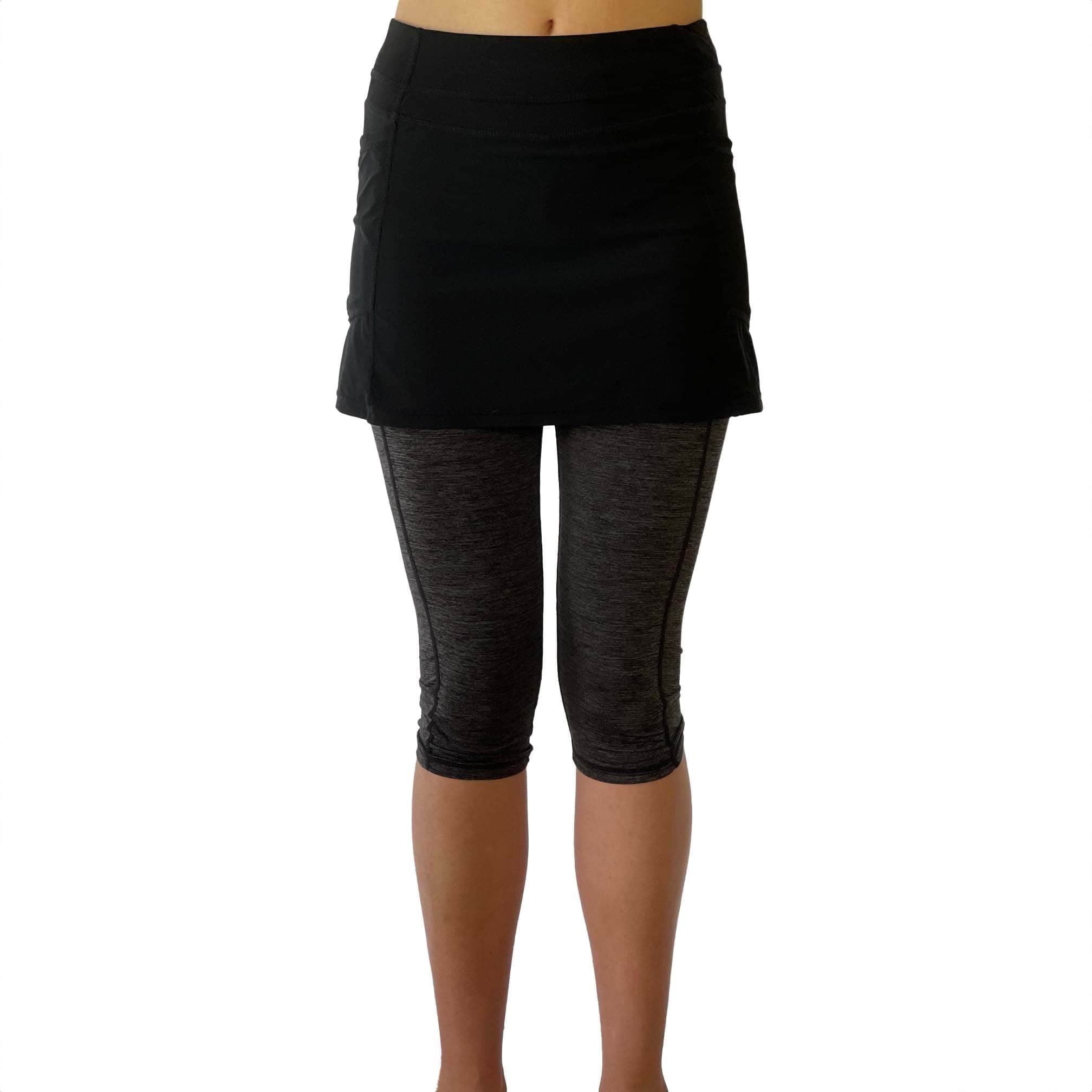 One piece black skirt with heather grey capris length leggings. Photo shows waist down shot of model wearing them from the front.