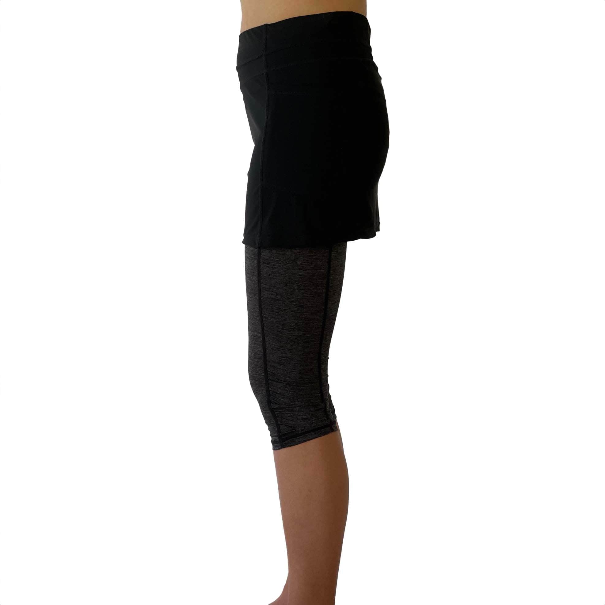 One piece black skirt with heather grey capris length leggings. Photo shows waist down shot of model wearing them from the side.