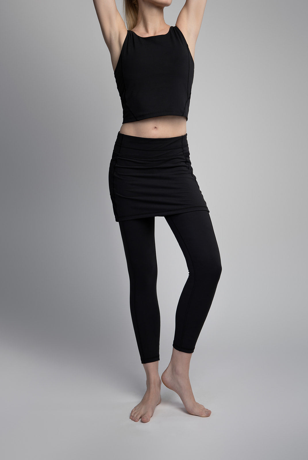 Black ankle length skirted leggings modeled by woman in studio