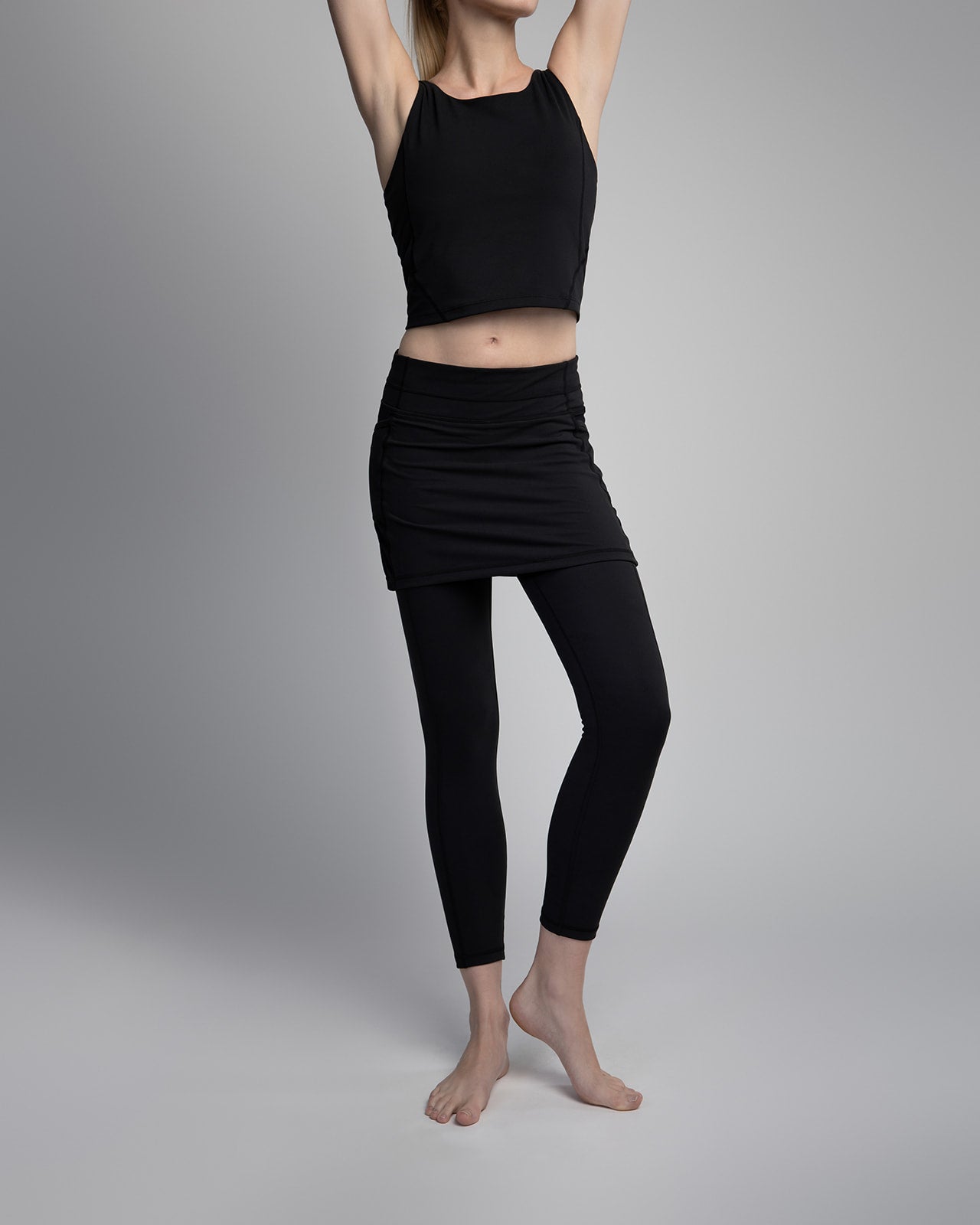 Black ankle length skirted leggings modeled by woman in studio