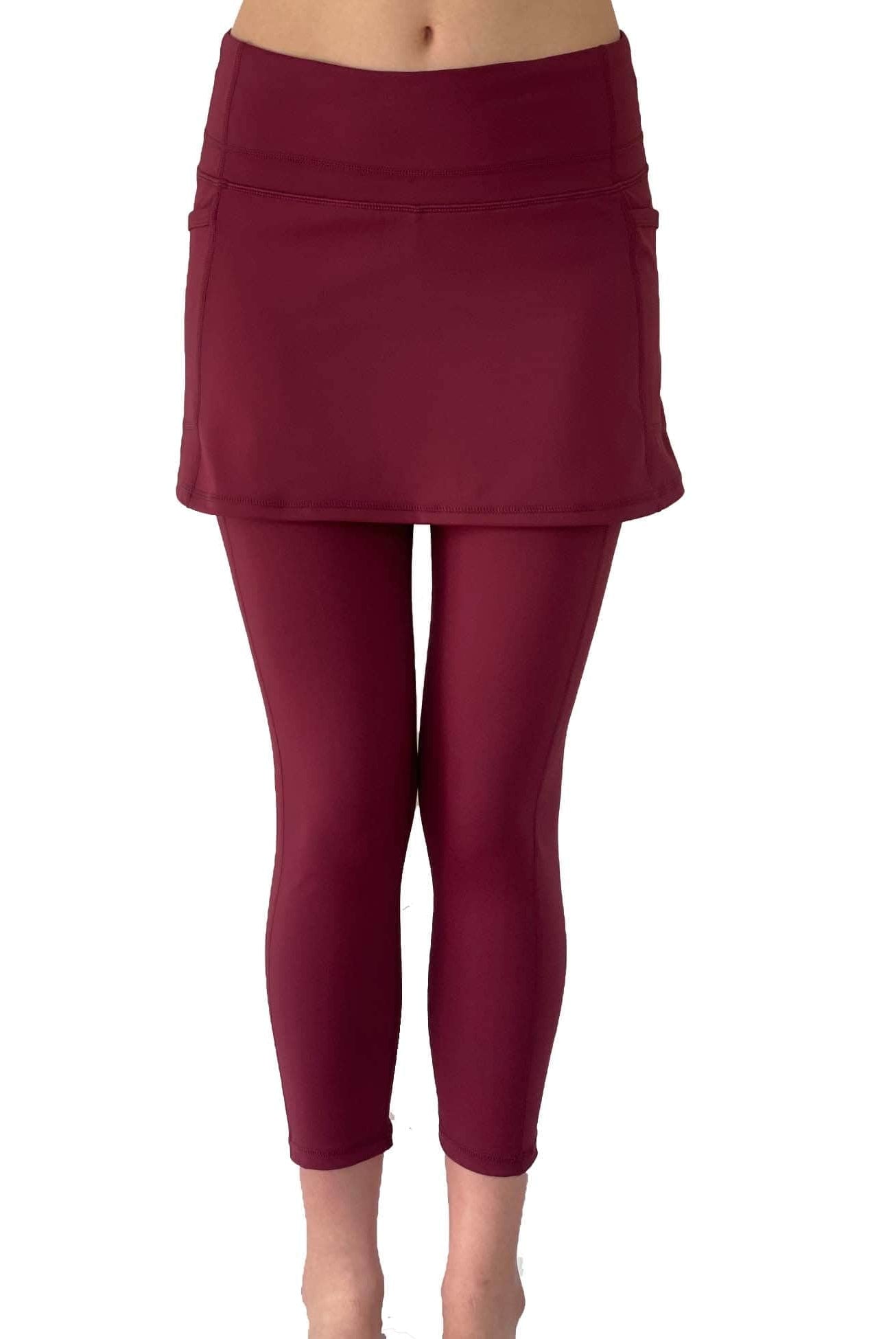 Model from waist down wearing cranberry colored 2-1 skirted leggings, front view.