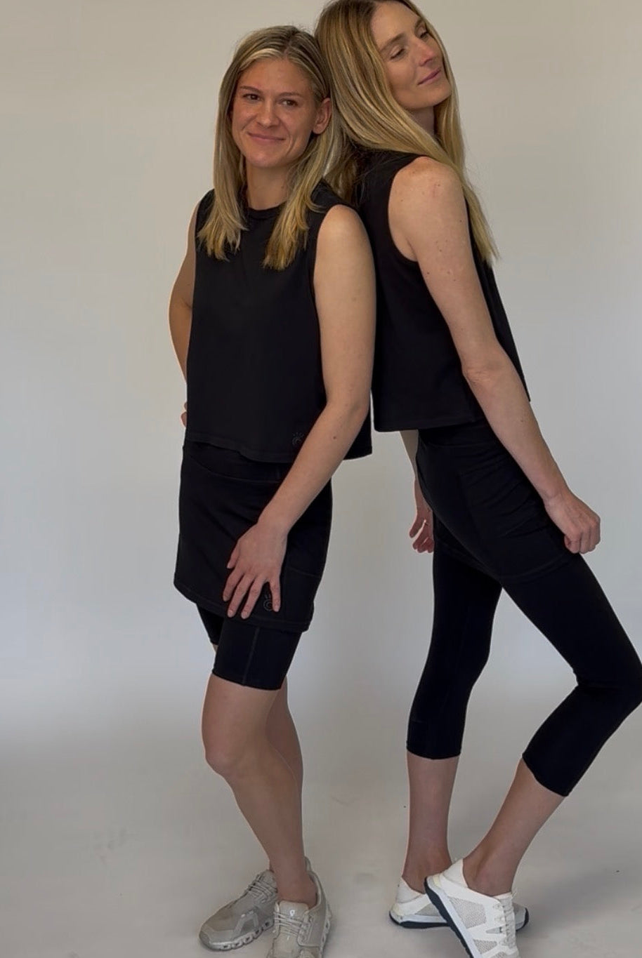 Two models wearing Black Cotton Skirted Leggings