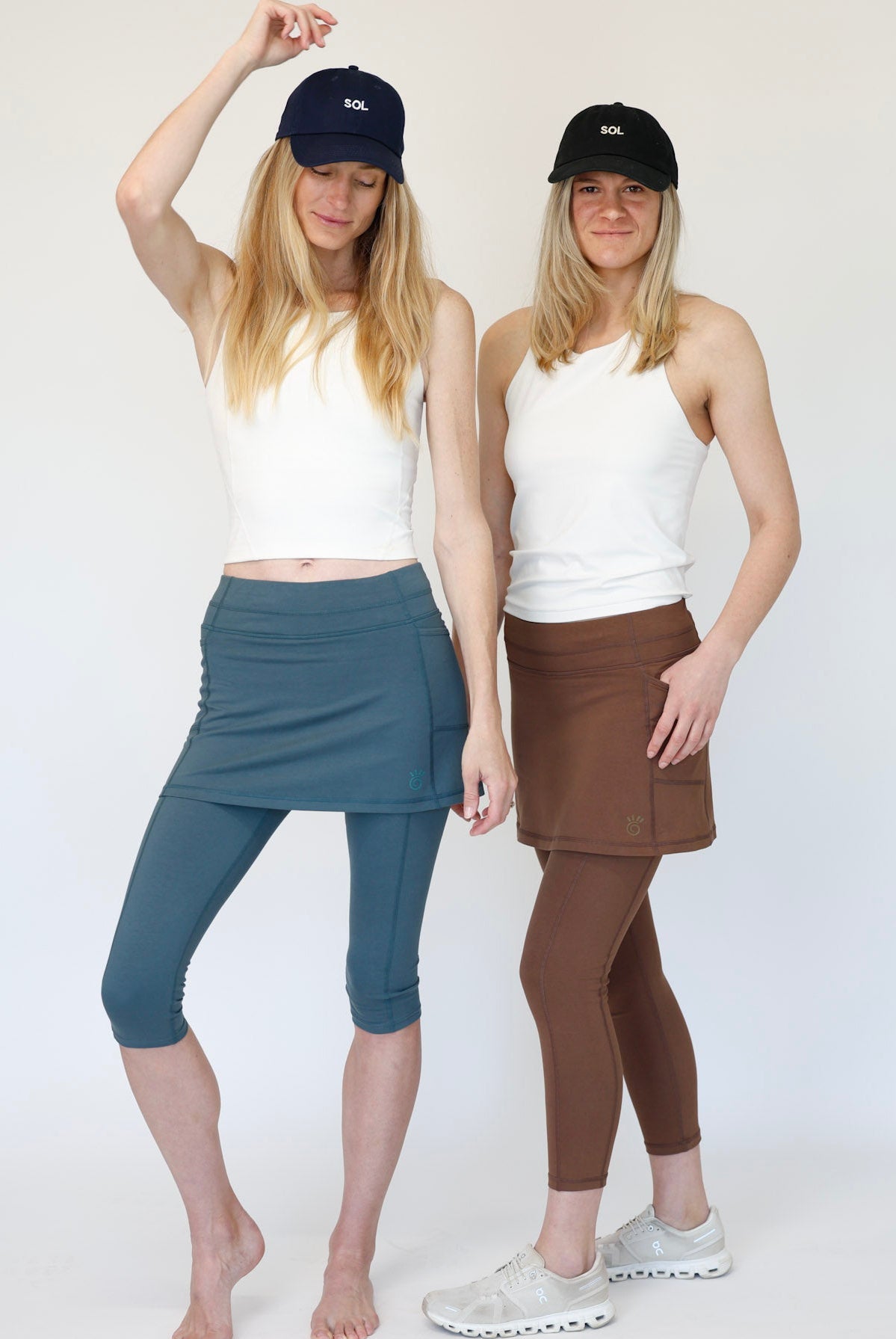 Two women wearing Blue Capris and Brown ankle length skirted leggings