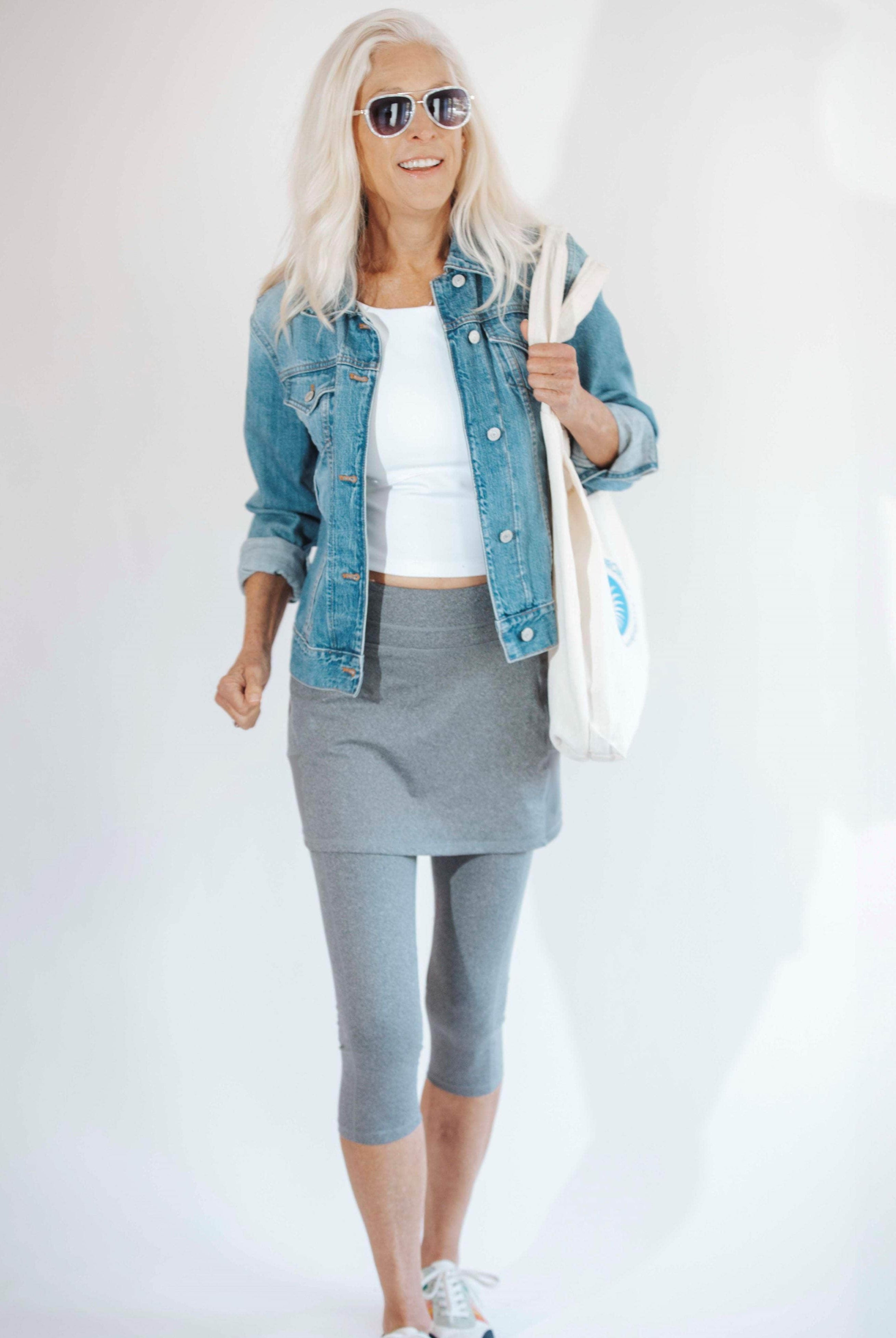 Model is wearing a heather grey 3/4 length leg skirted legging with white t-shirt and blue jean jacket.