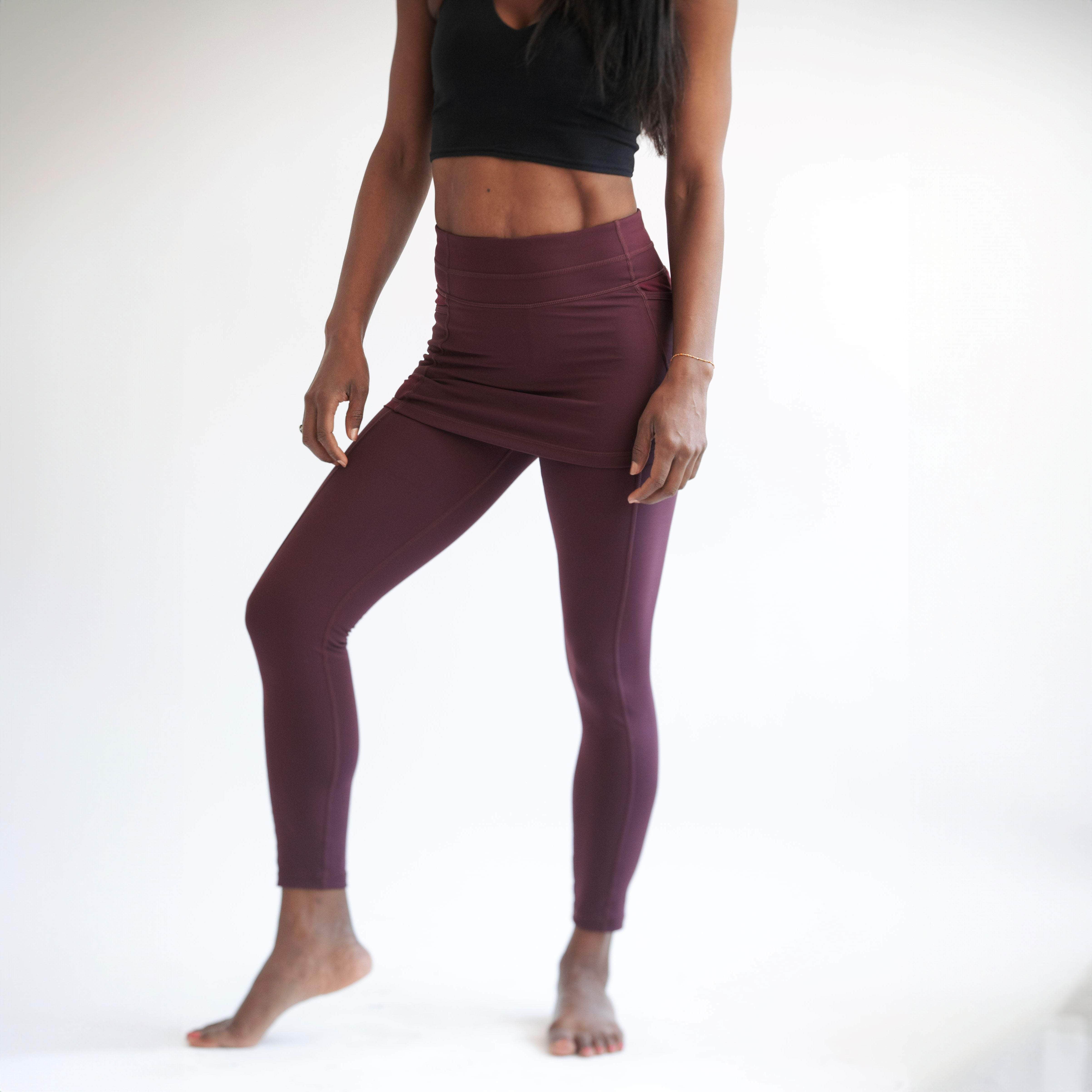 Studio shot of model wearing pretty Maroon colored ankle length skirted leggings with black crop top.