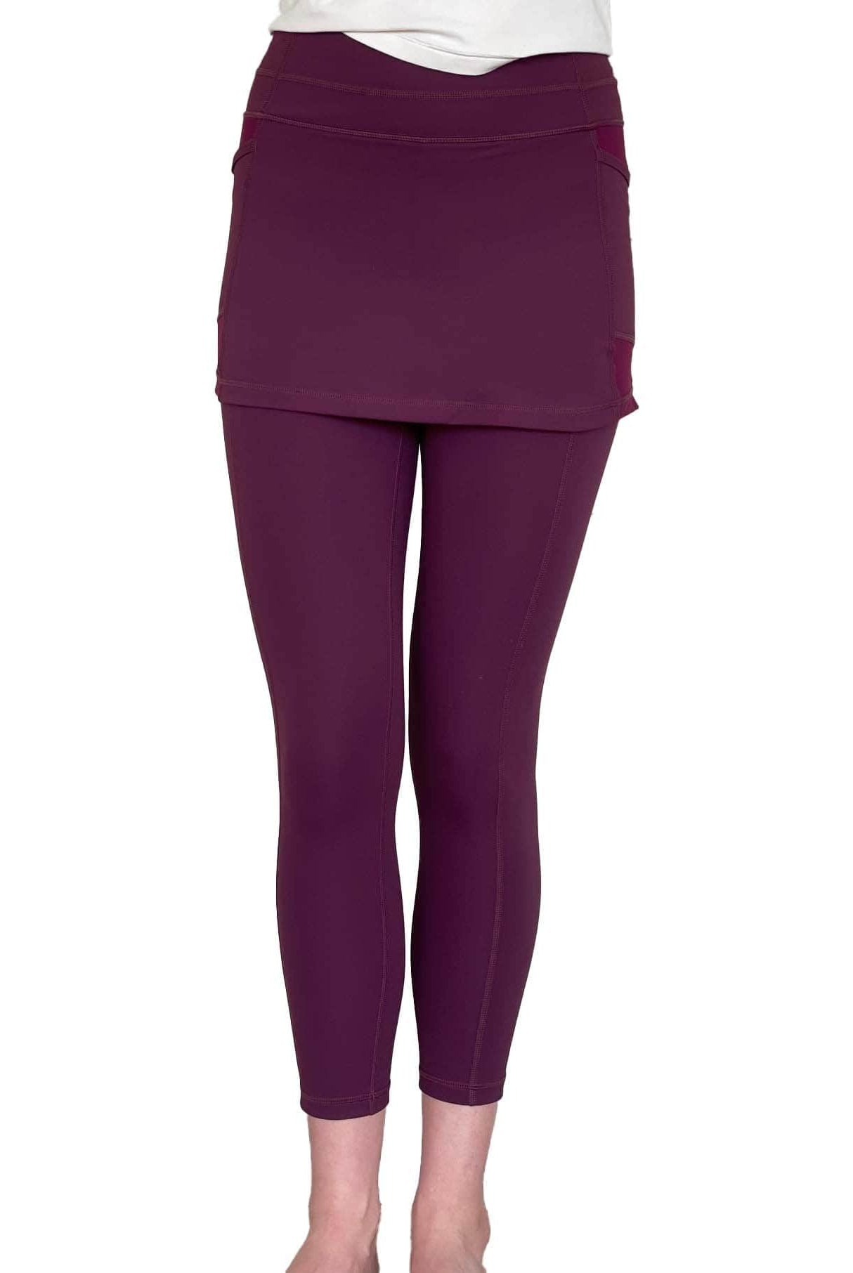 Studio shot of model from waist down wearing Eggplant Maroon 2-1 Skirted Ankle-Length Leggings from front