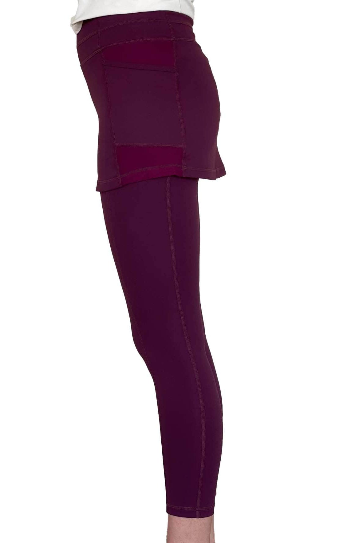 Studio shot of model from waist down wearing Eggplant Maroon 2-1 Skirted Ankle-Length Leggings from side