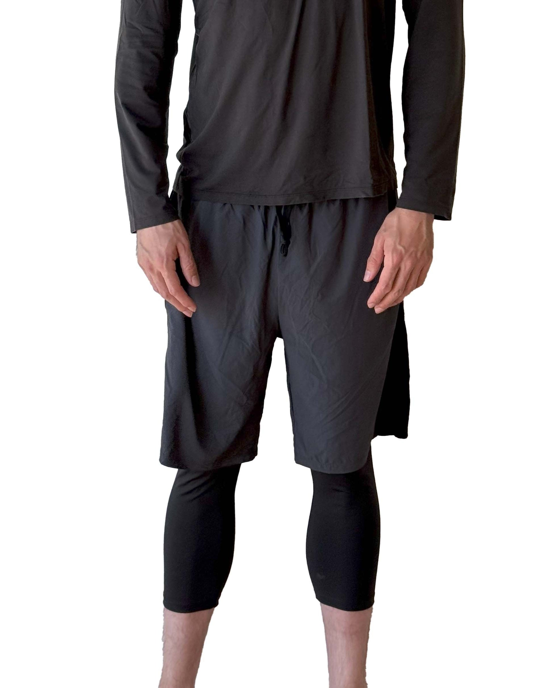 Male model wearing Sol Sister Mister Men's 2-1 Shorts with Midcalf length Leggings taken chest down from front.