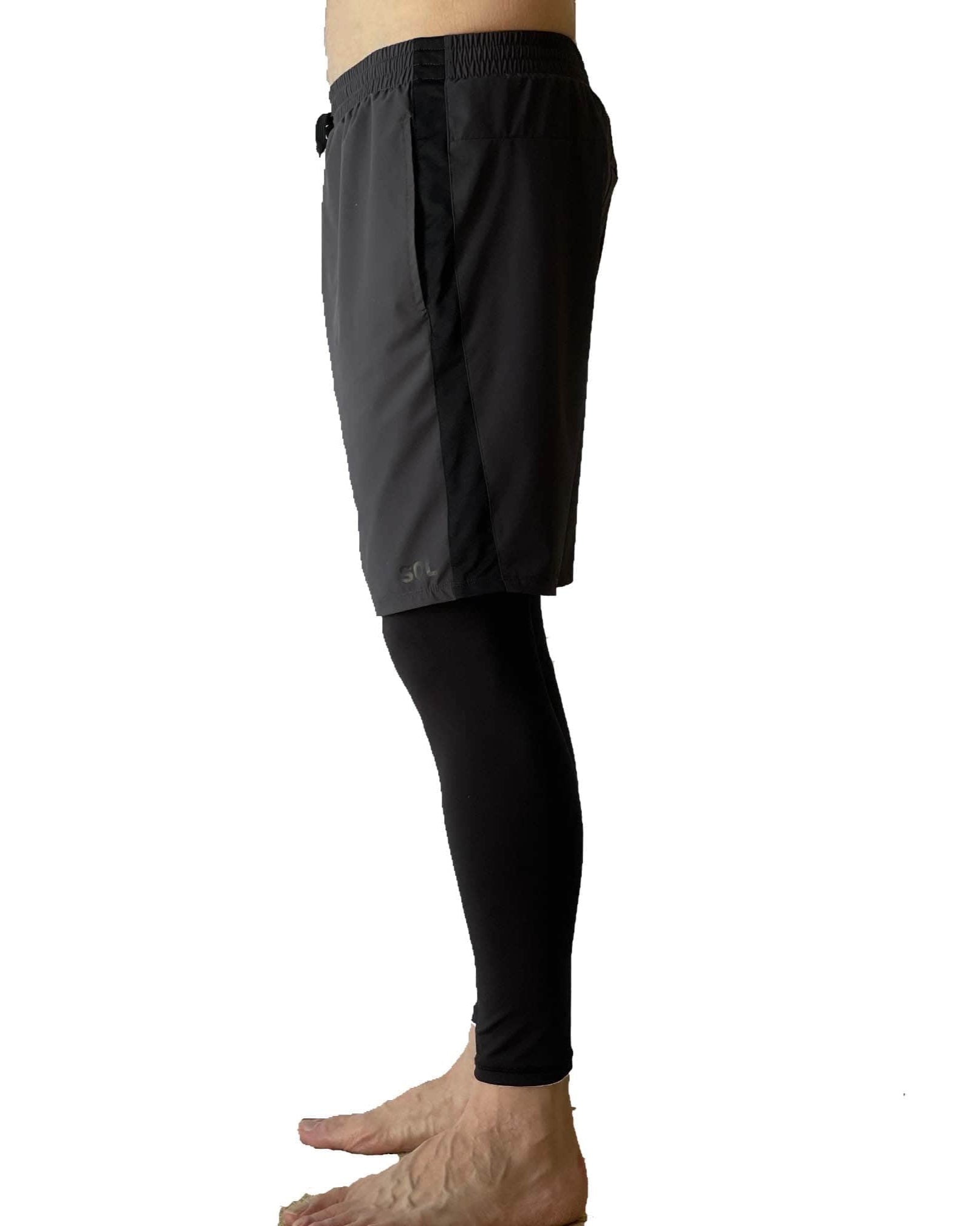 Male model wearing Sol Sister Mister Men's 2-1 Shorts with Leggings taken waist down from side.