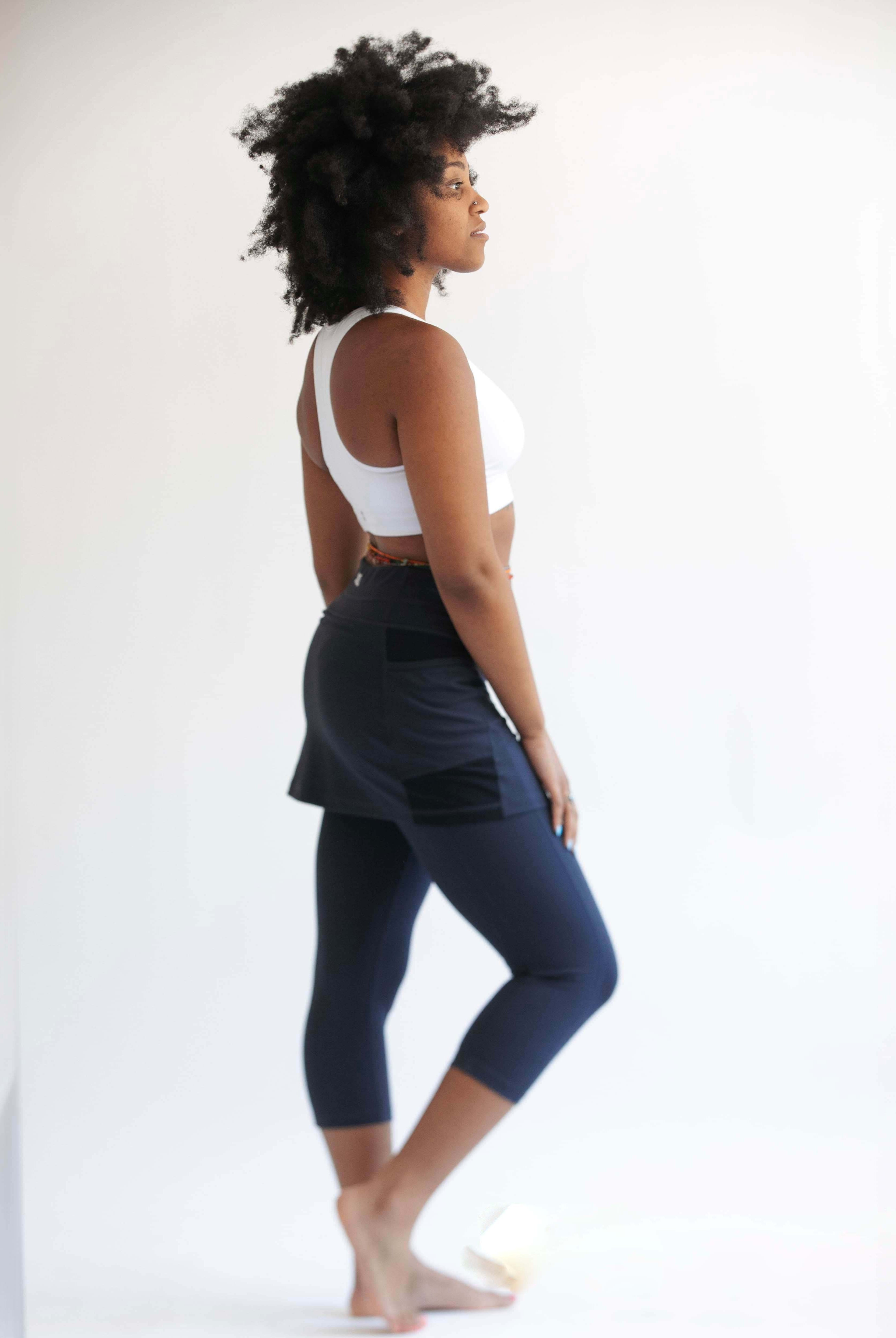 Studio shot of model wearing Midnight Capris 2-1 Skirted Leggings from side