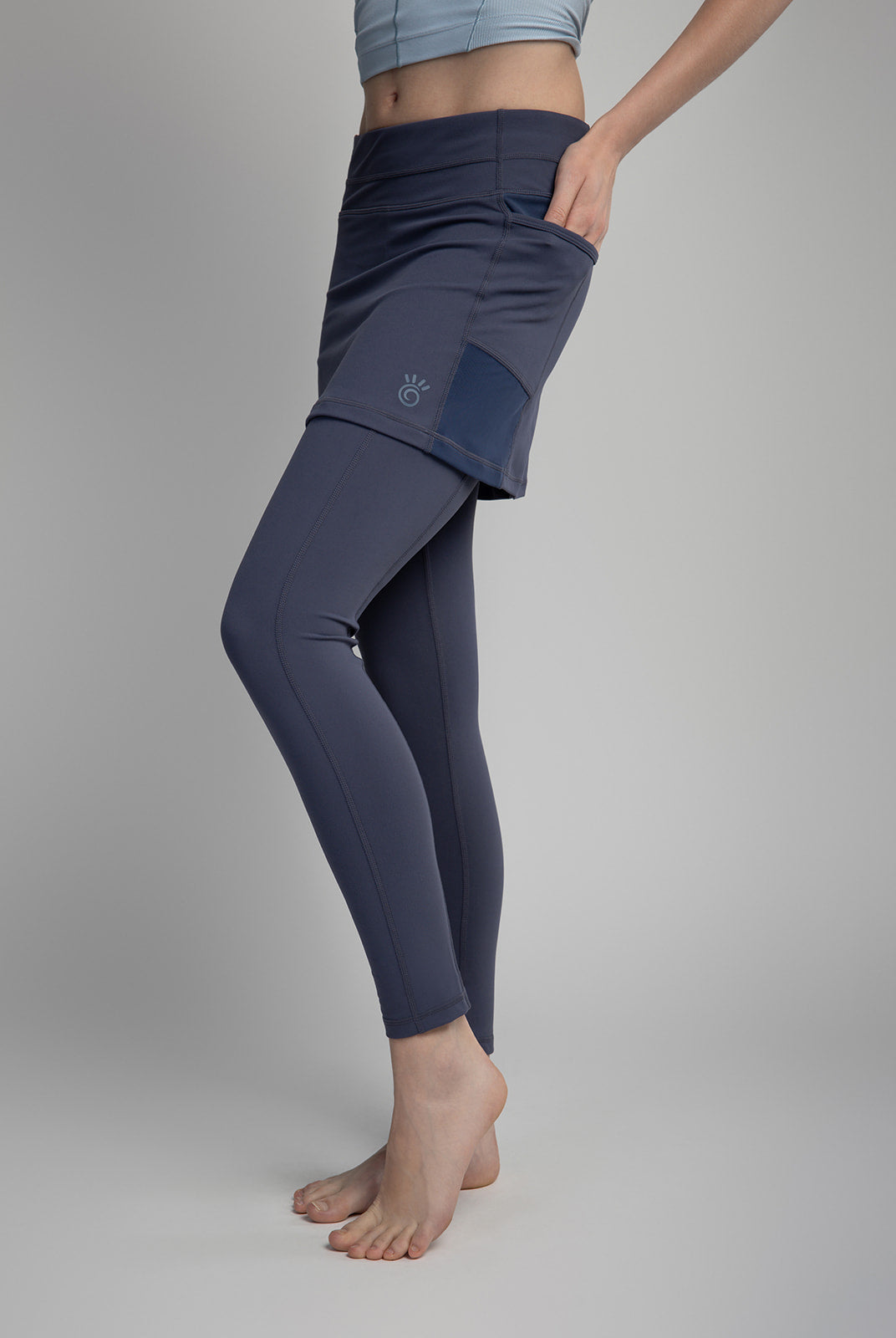Studio shot of model wearing 2-1 Nordic Dusk colored Ankle-Length Skirted Leggings - Sol Sister Sport