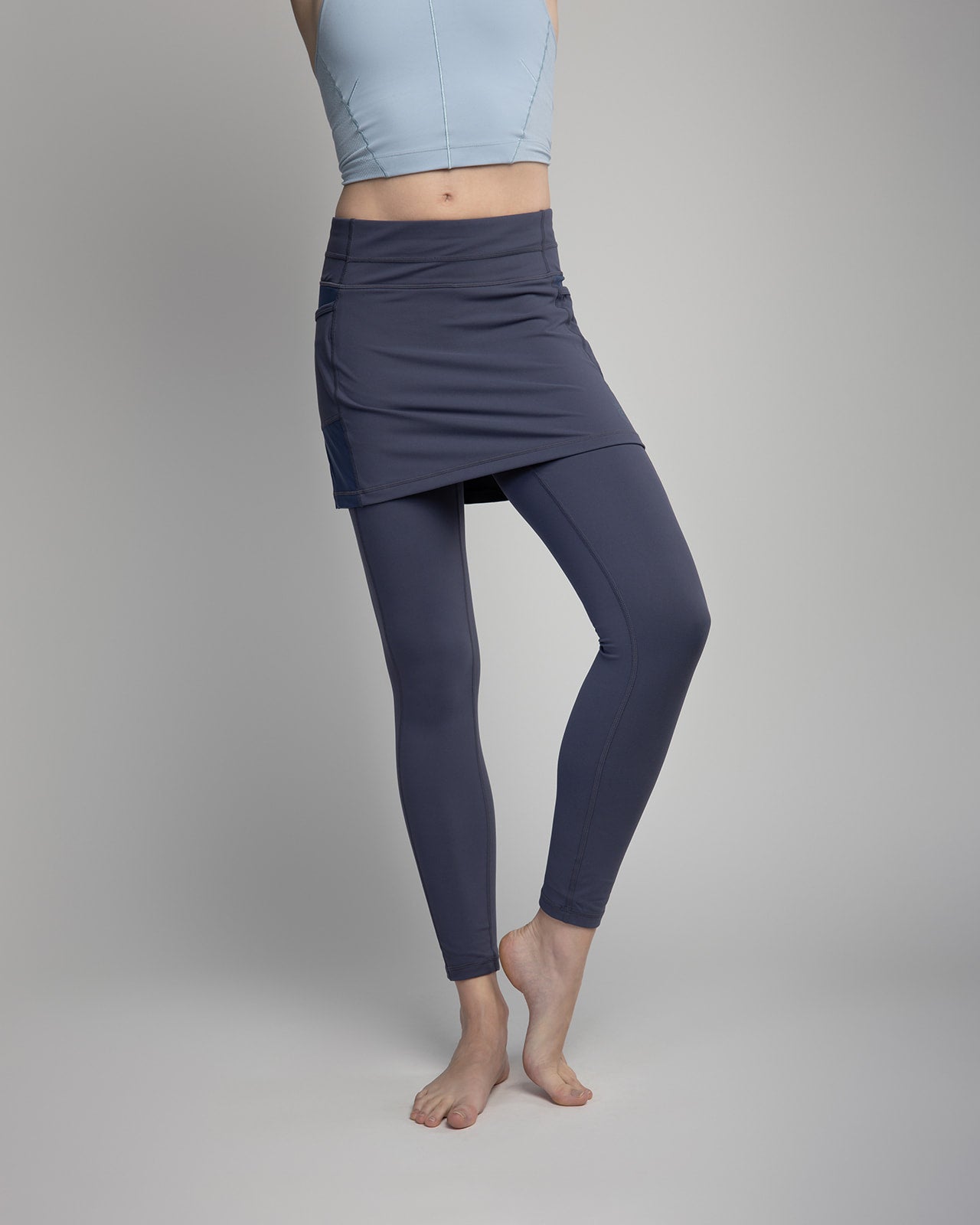 Studio shot of model wearing 2-1 Nordic Dusk colored Ankle-Length Skirted Leggings - Sol Sister Sport