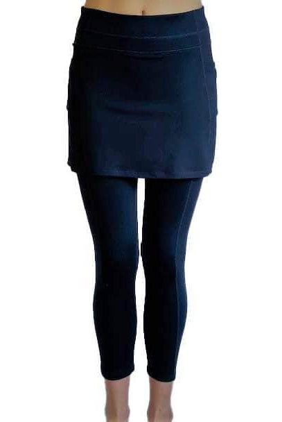 Woman wearing Navy mid-calf legging length skirted leggings from waist down with white background from front view.