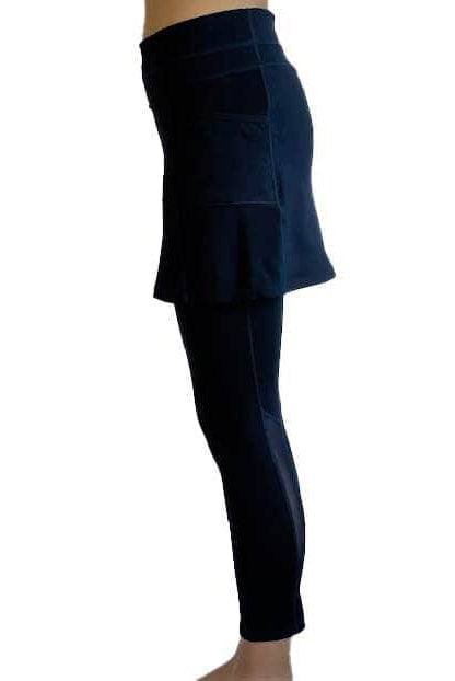 Woman wearing Navy mid-calf legging length skirted leggings from waist down with white background from side view.