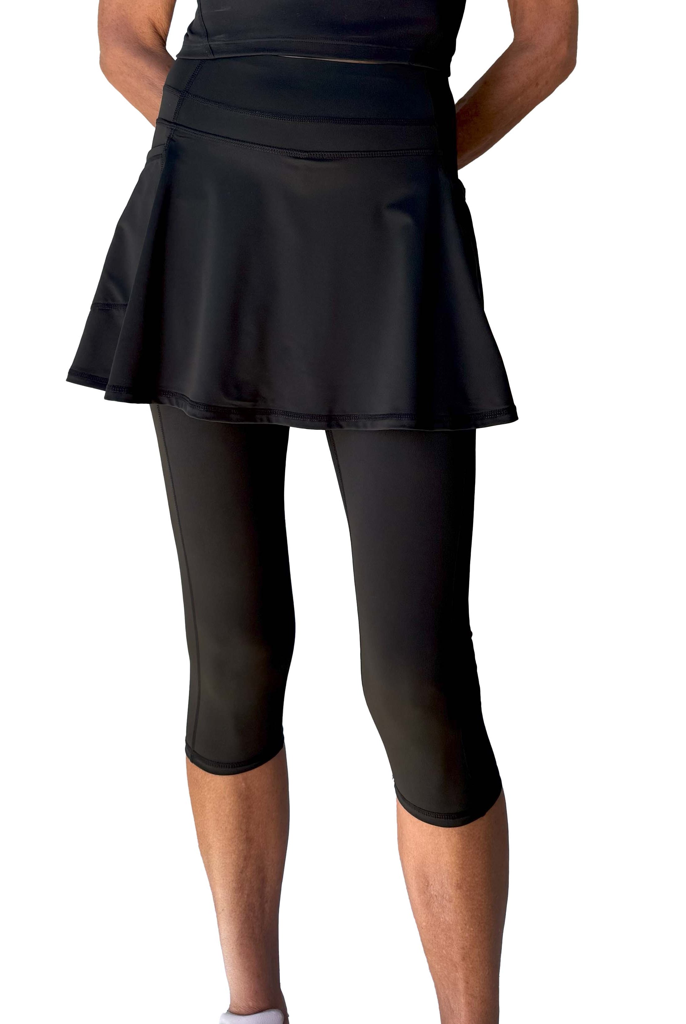 Black athletic skirted capris length leggings on a white background