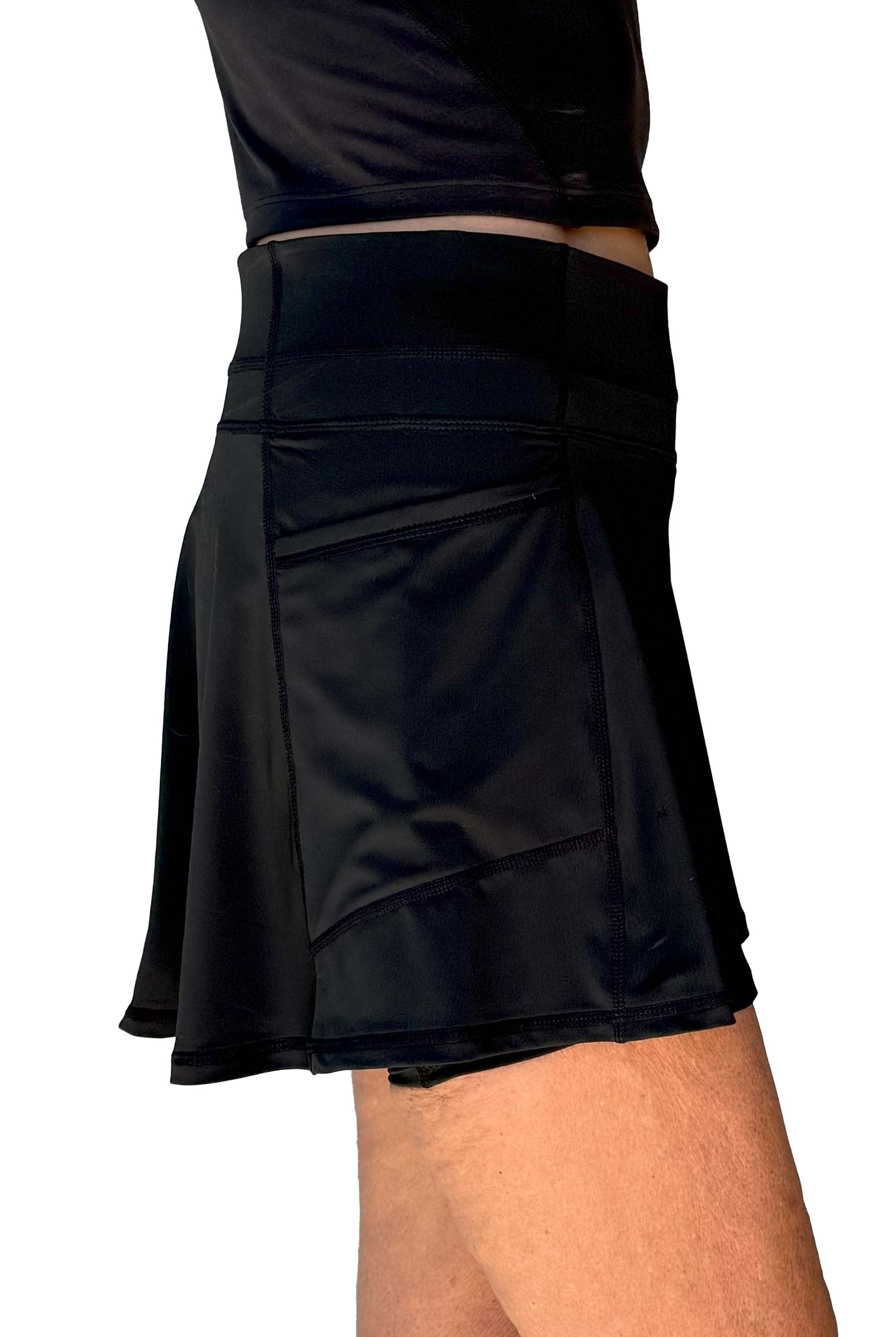 Black flared athletic skort worn by a person on a white background