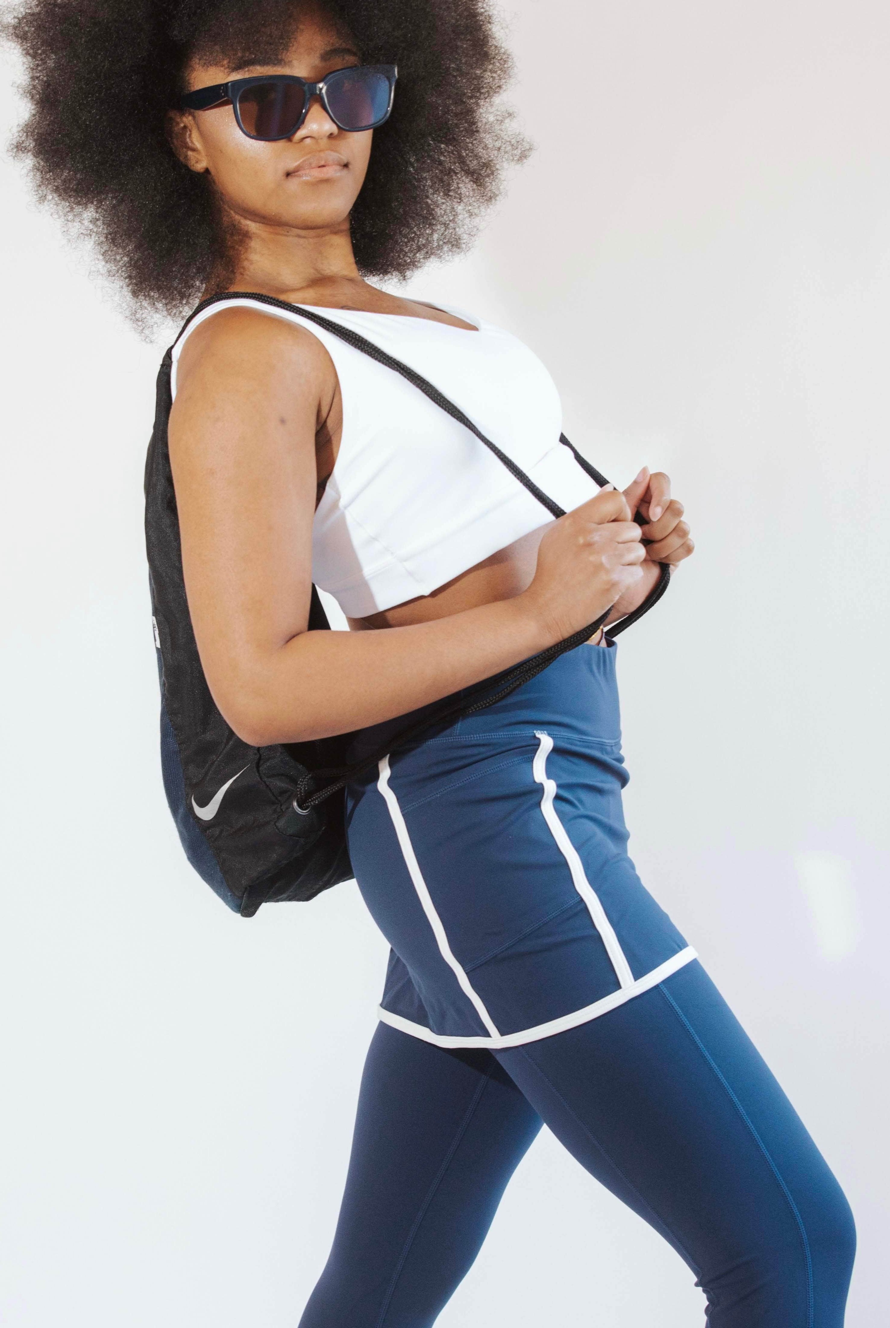 Woman wearing navy skirted leggings with white piping on skirt
