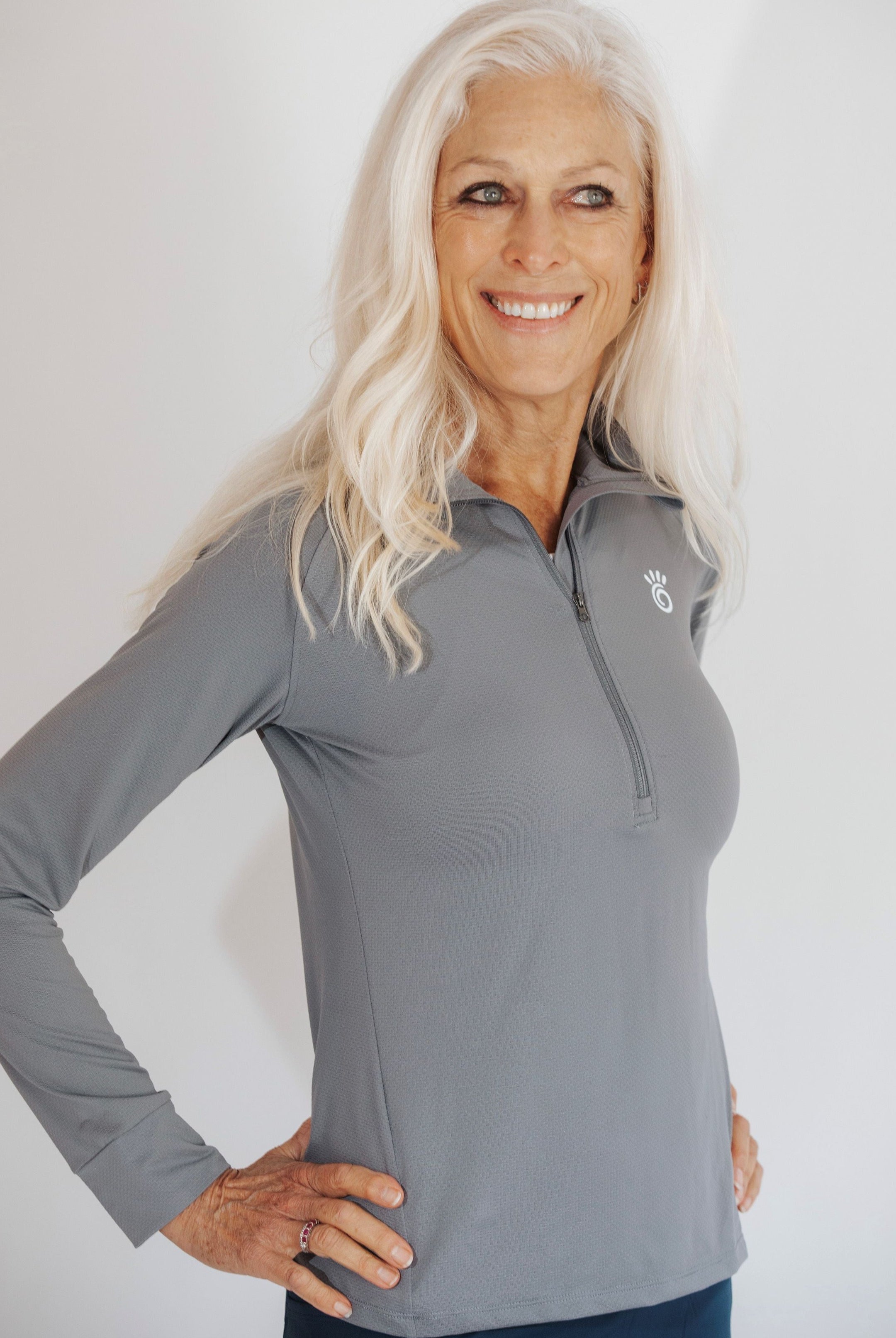 Close up shot of silver haired model wearing a pretty grey 1/4 zip athletic shirt.