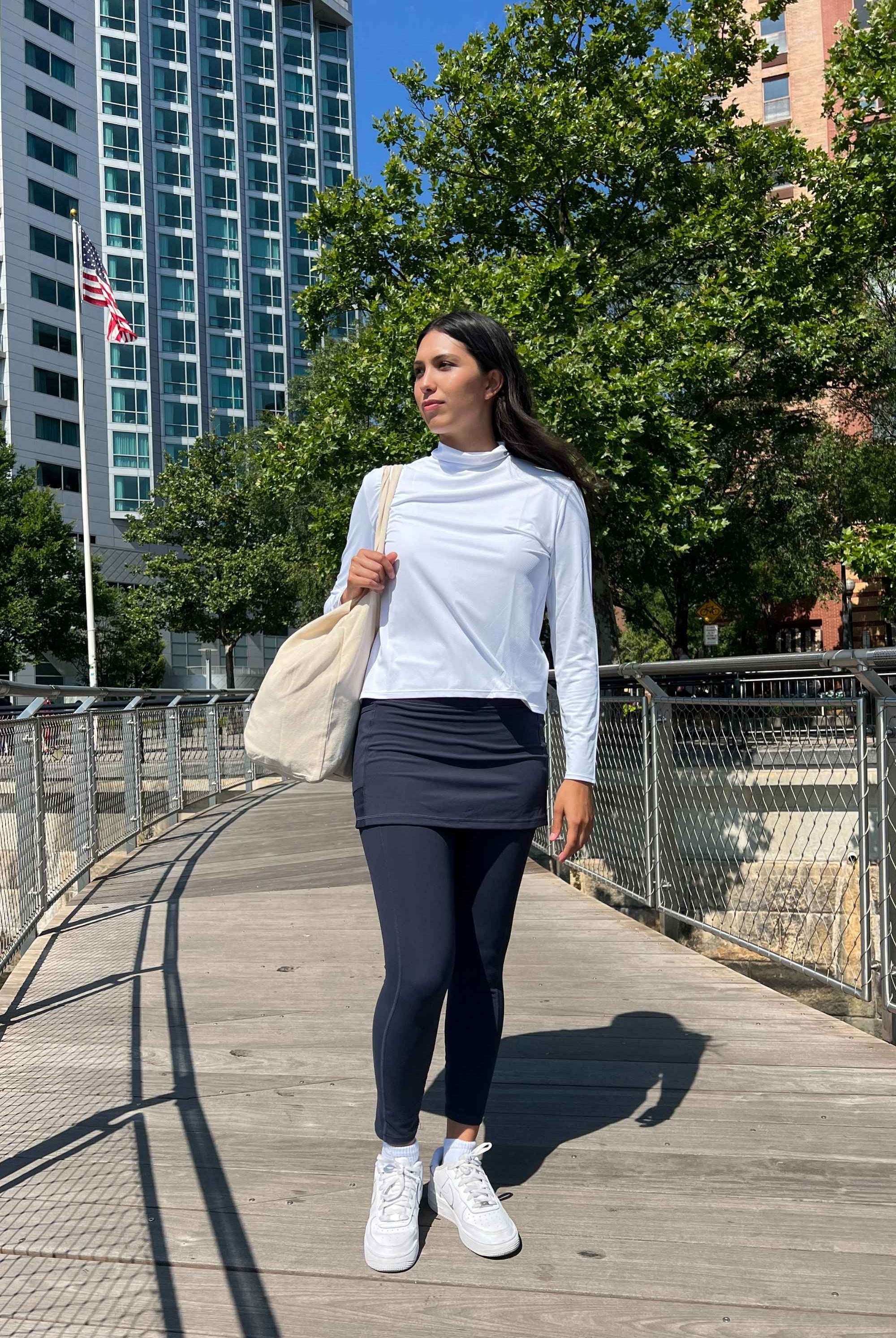 Black ankle length skirted leggings modeled by woman