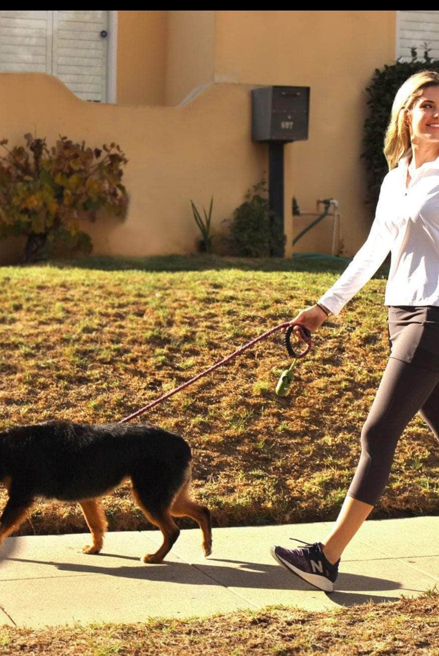 Model walking dog while wearing 2-1 Original Skirted Mid-calf Length Leggings in Steel - Sol Sister Sport