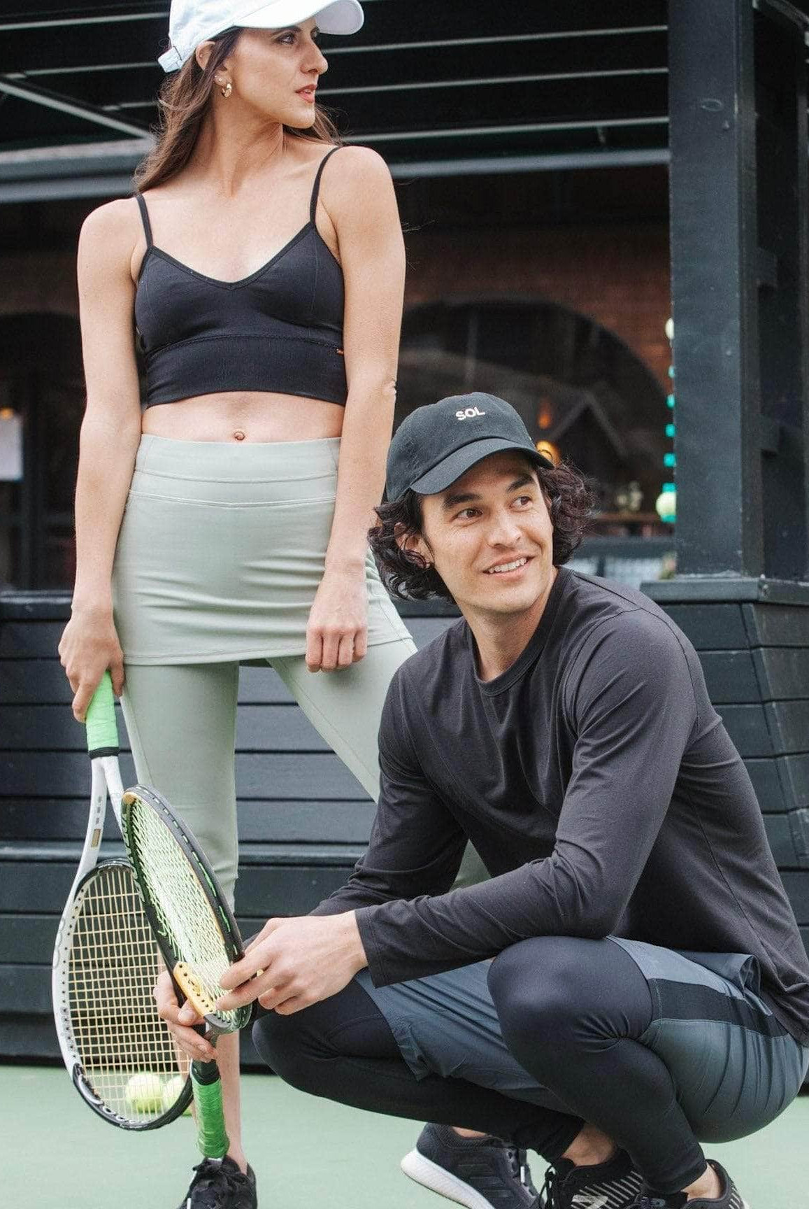 Male model waering Sol Sister Mister Men's 2-1 Shorts with Leggings and female model wearing Sol Sister Sport SCapris length Sage colored skirted leggings.