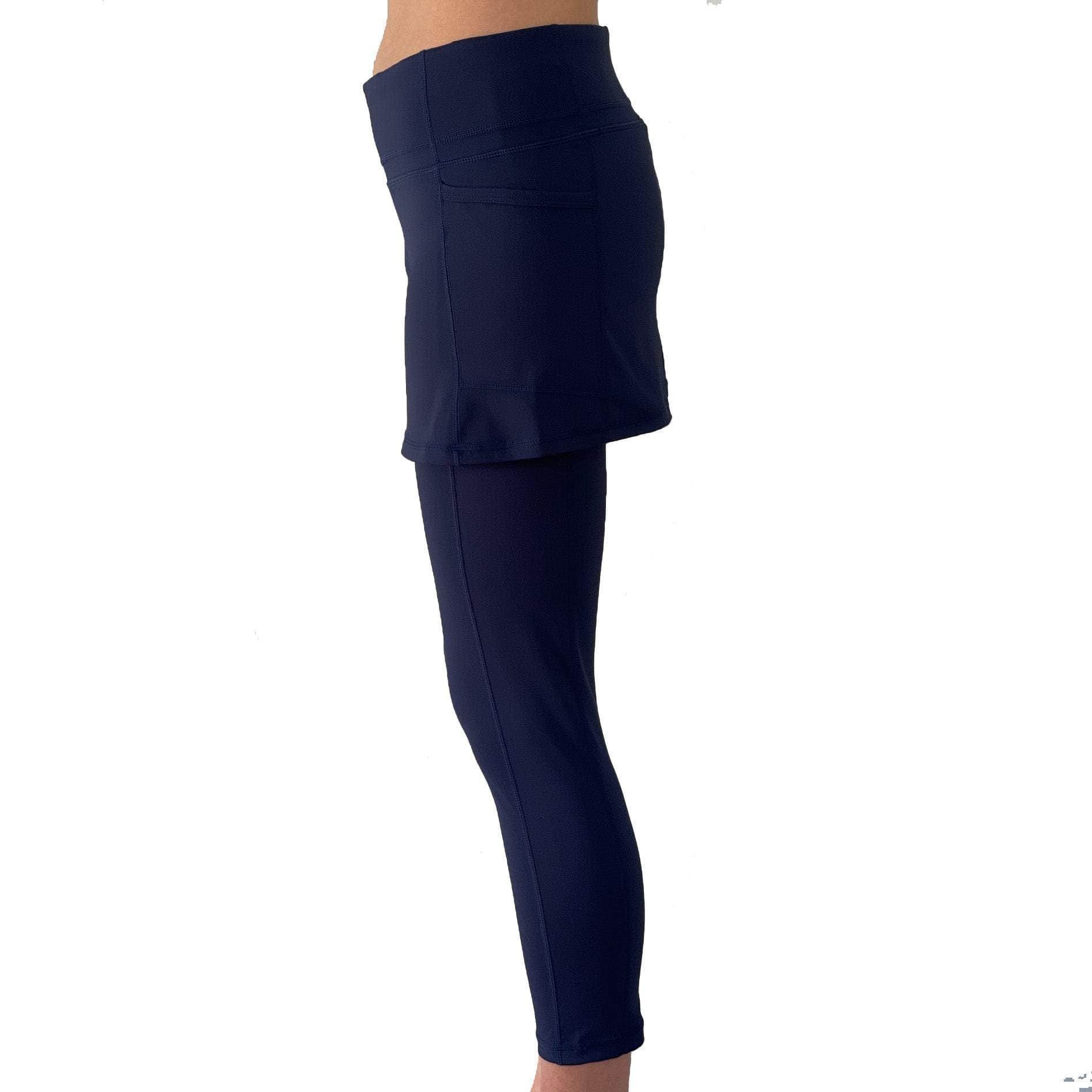 model wearing navy blue skirted leggings waist down from side view.