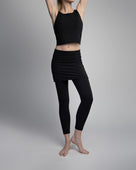 Black ankle length skirted leggings modeled by woman in studio