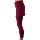 Model from waist down wearing cranberry colored 2-1 skirted leggings, side view.