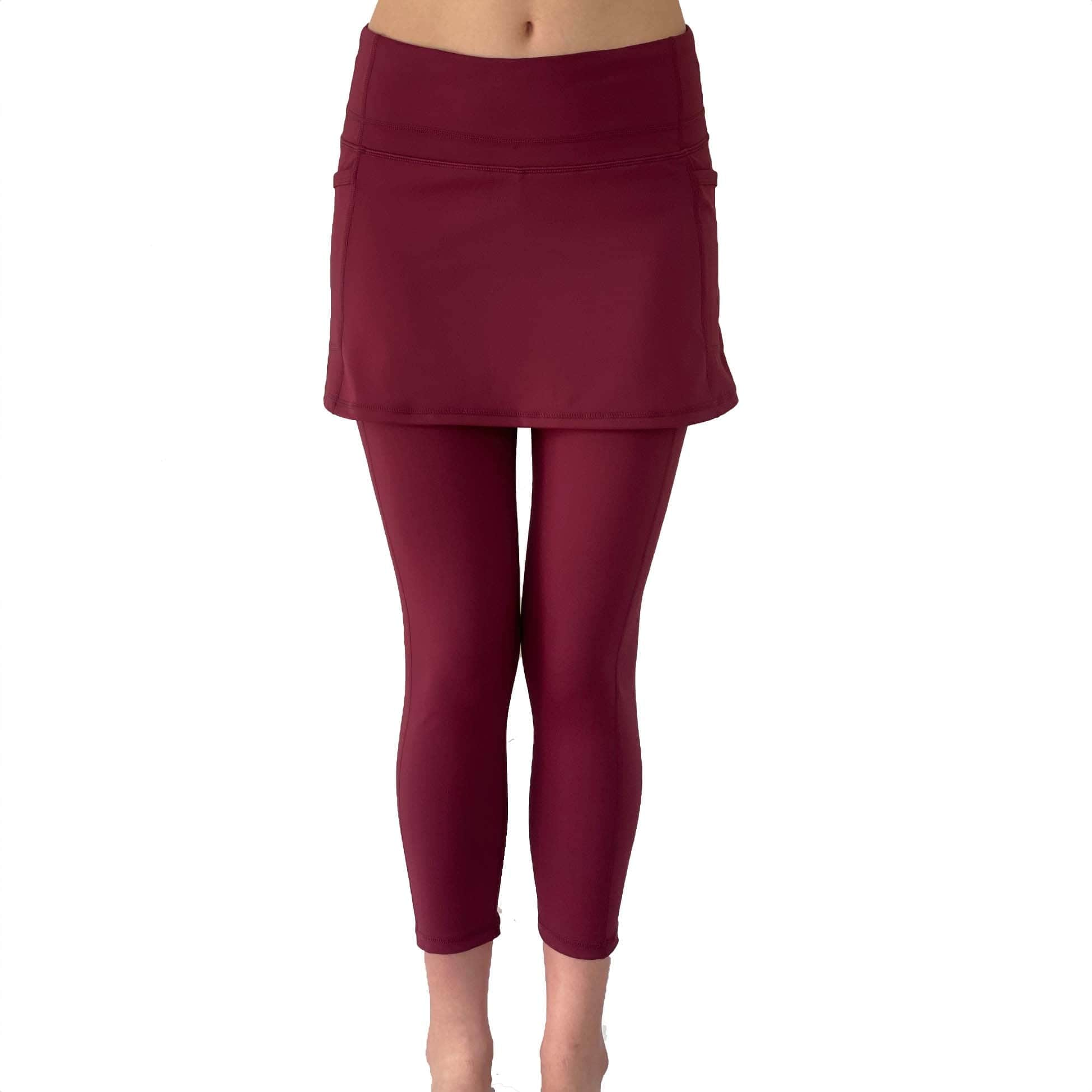 Model from waist down wearing cranberry colored 2-1 skirted leggings, front view.