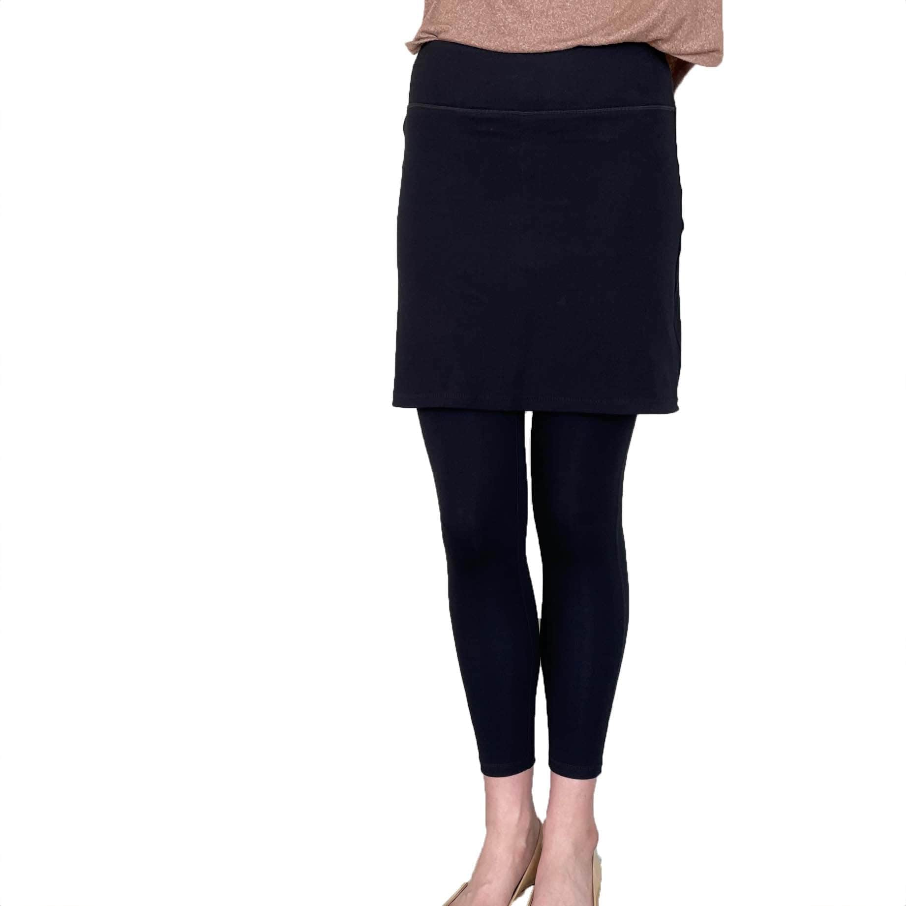 Woman wearing black skirted leggings with 17 inch skirt from front waist down to feet.