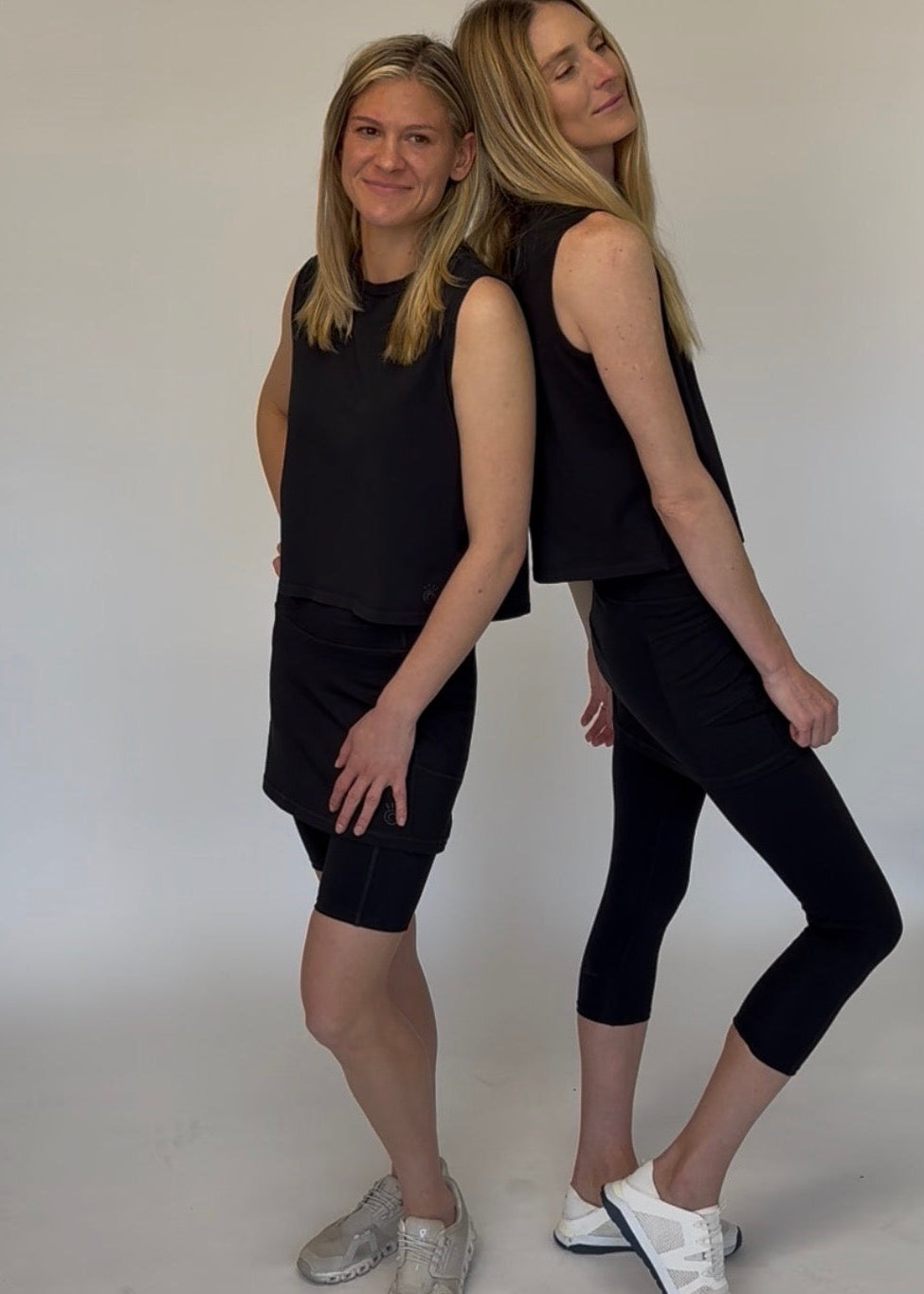 Two models wearing Black Cotton Skirted Leggings