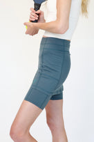 Person wearing blue skirted bike shorts on a plain background
