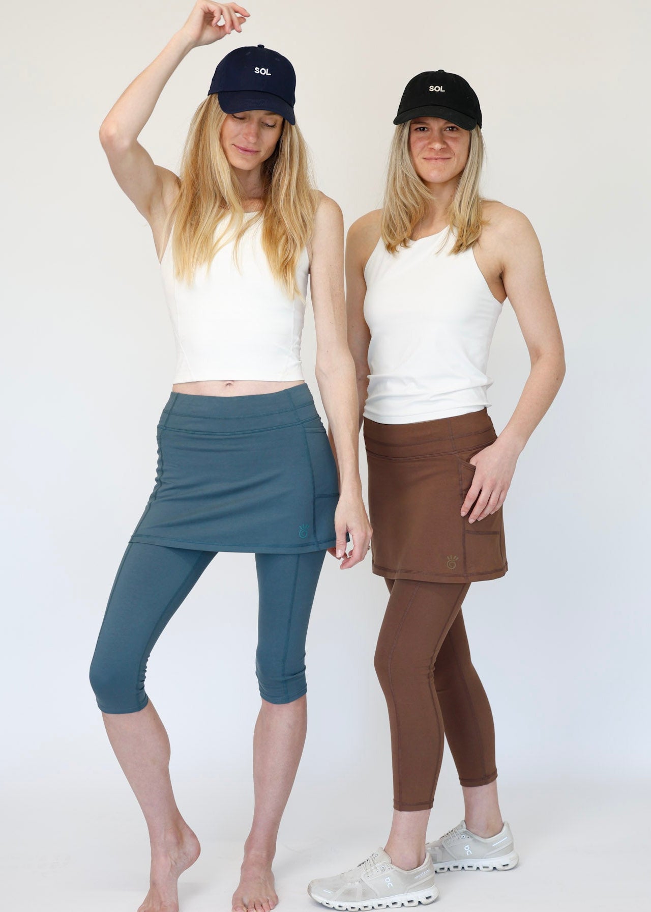 Two women wearing Blue Capris and Brown ankle length skirted leggings