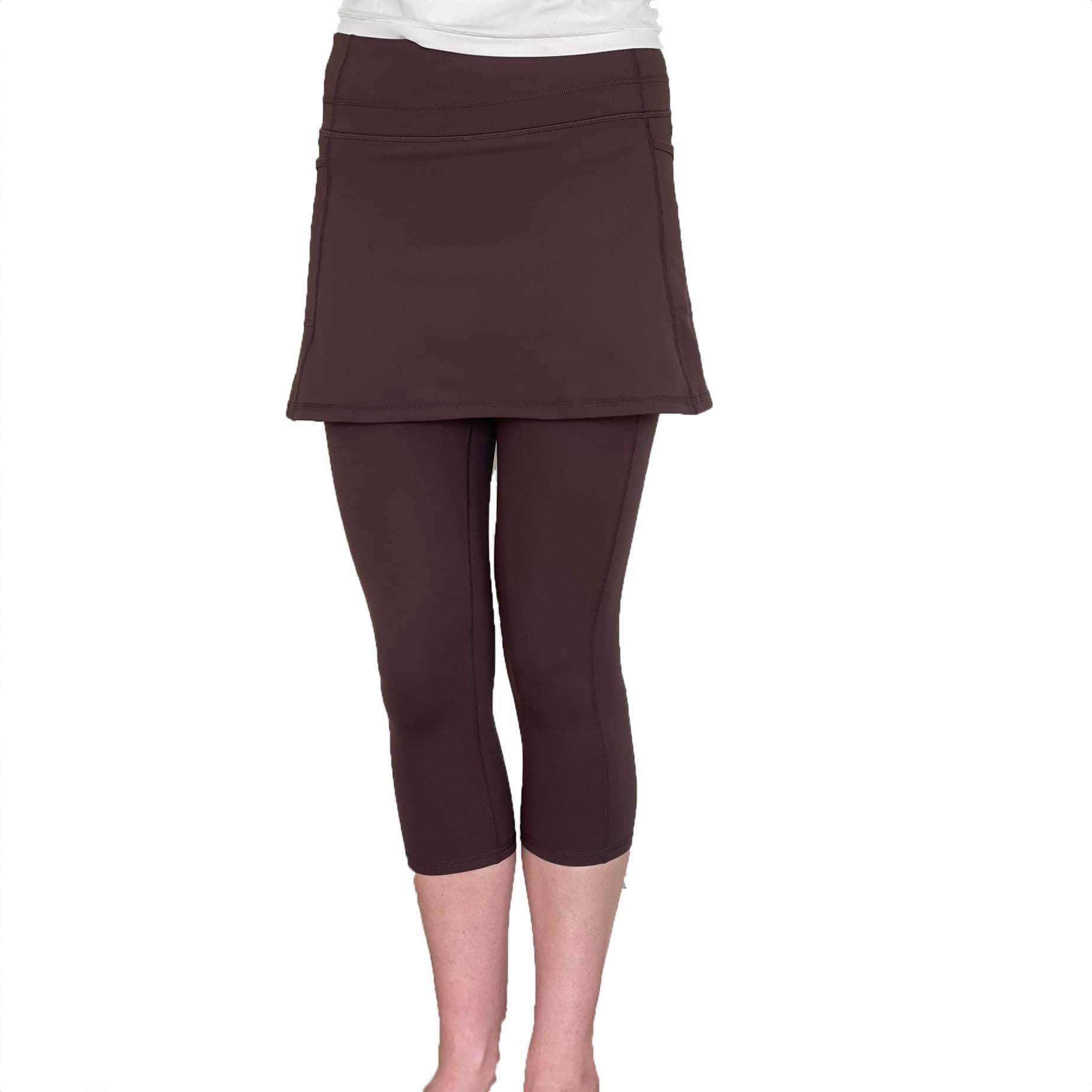 Studio shot of model from waist down wearing Espresso Brown 2-1 Skirted Ankle-Length Leggings from front