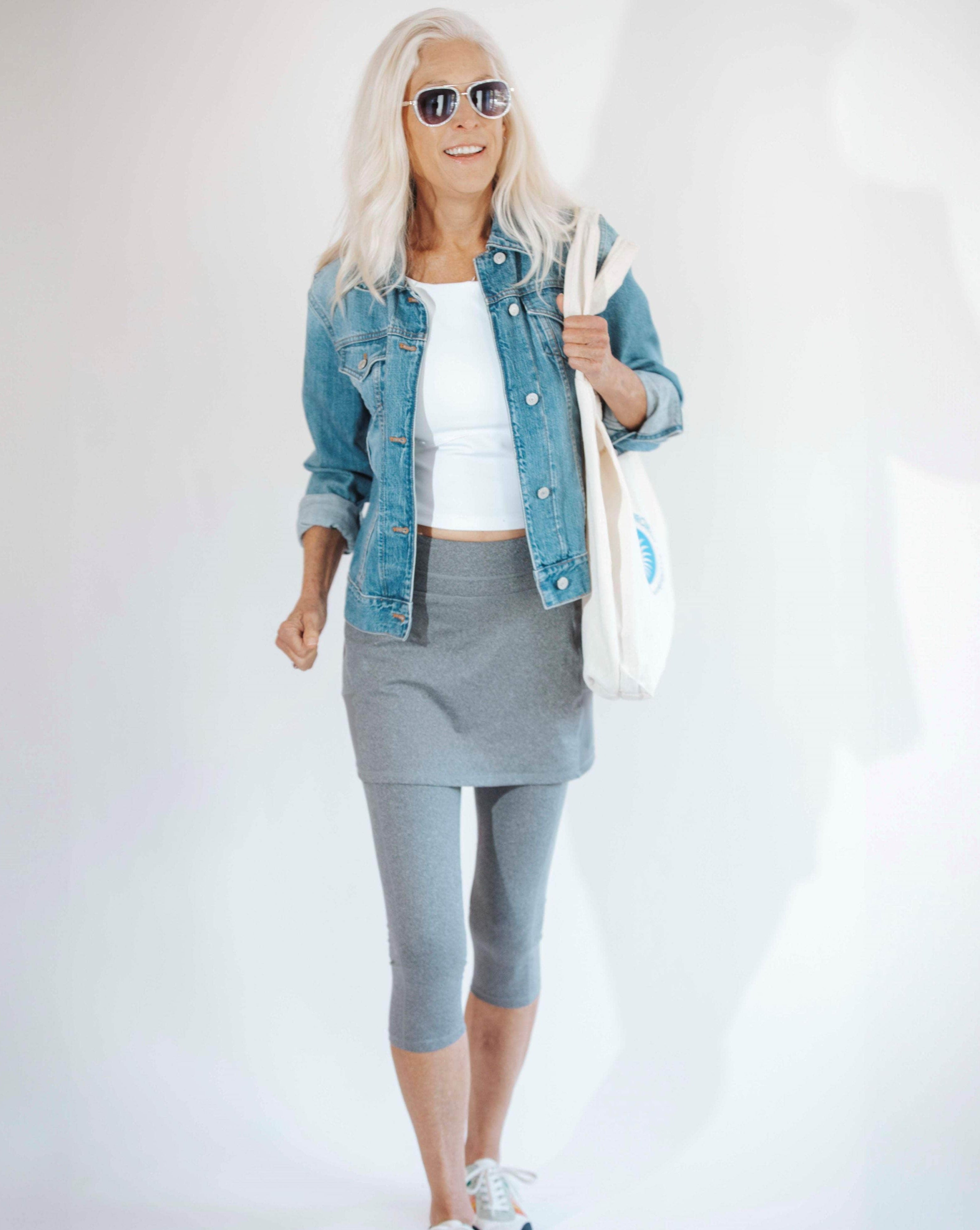 Model is wearing a heather grey 3/4 length leg skirted legging with white t-shirt and blue jean jacket.