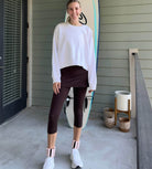 Shot of model on porch wearing Espresso Brown 2-1 Skirted Ankle-Length Leggings from front angle