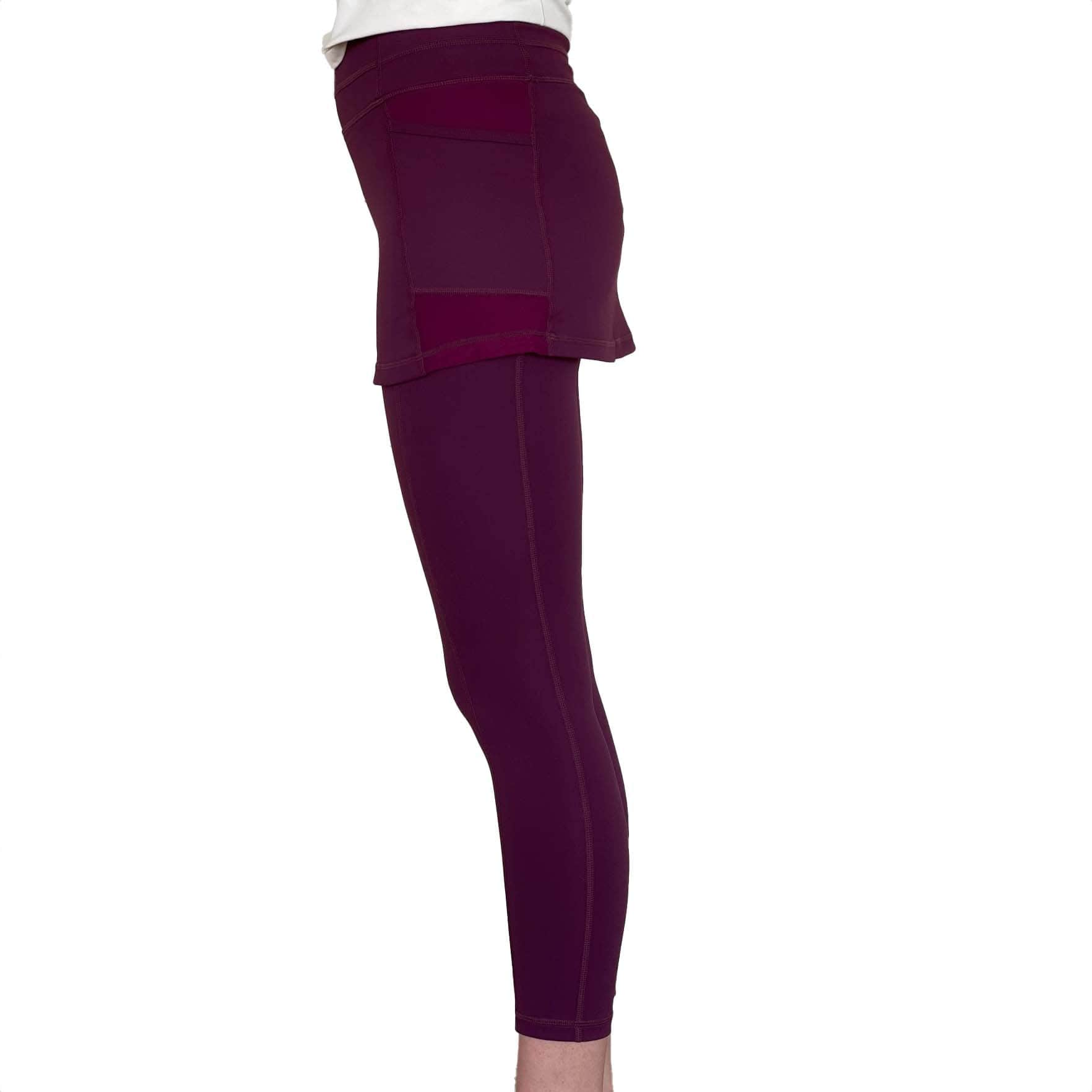 Studio shot of model from waist down wearing Eggplant Maroon 2-1 Skirted Ankle-Length Leggings from side