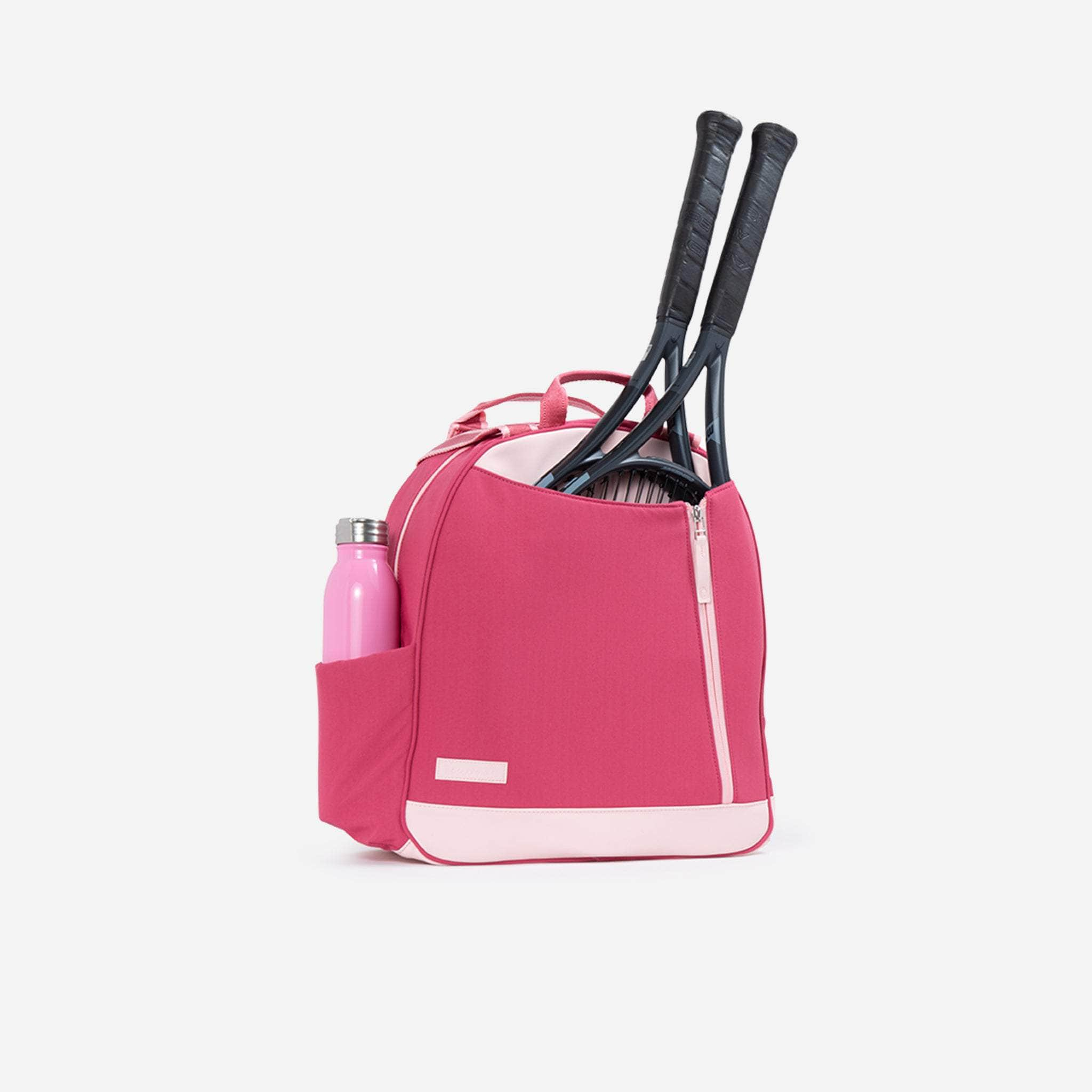 Pink tennis backpack with two racquets sticking out.