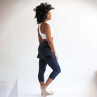 Studio shot of model wearing Midnight Capris 2-1 Skirted Leggings from side