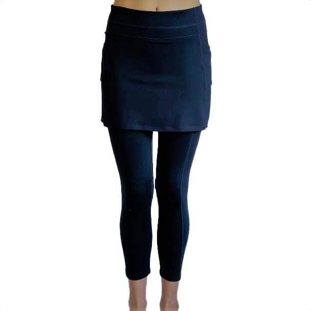 Woman wearing Navy mid-calf legging length skirted leggings from waist down with white background from front view.