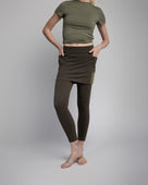 Studio shot of Model wearing 7/8ths length pretty olive skirted leggings 