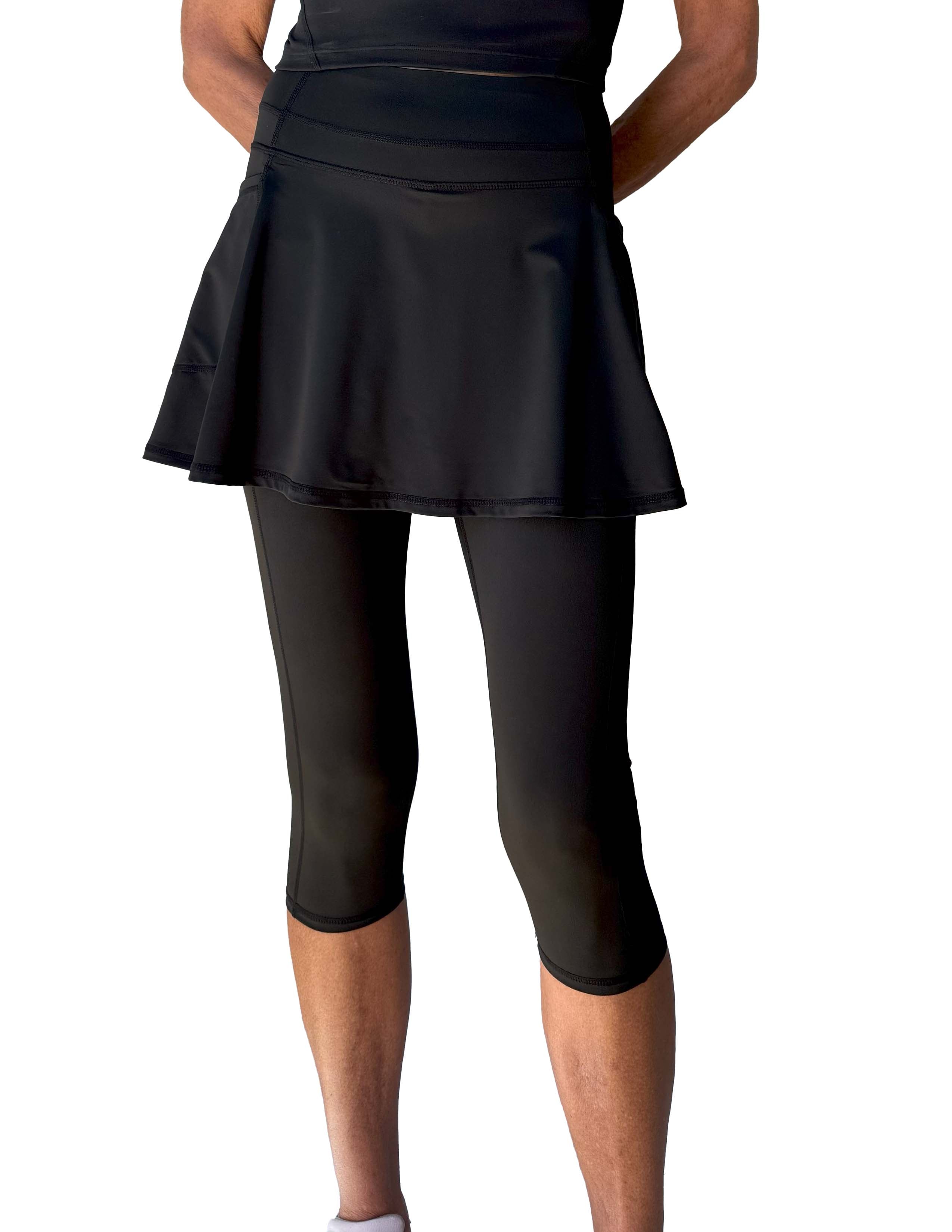 Black athletic skirted capris length leggings on a white background