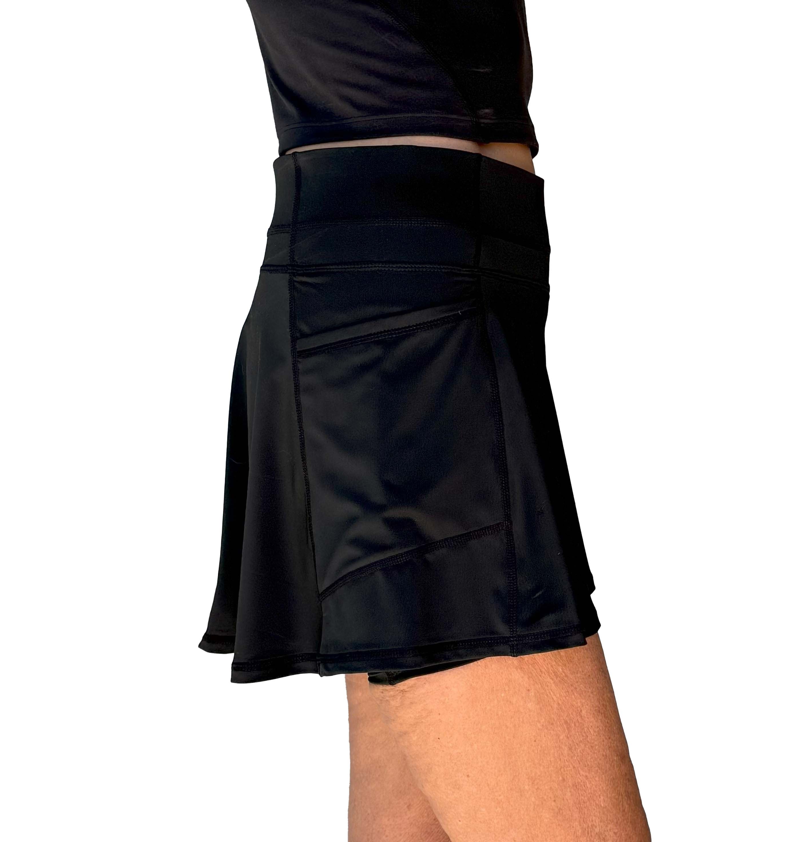 Black flared athletic skort worn by a person on a white background