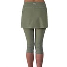 Studio shot waist down of model wearing sage green skirted leggings  from back.