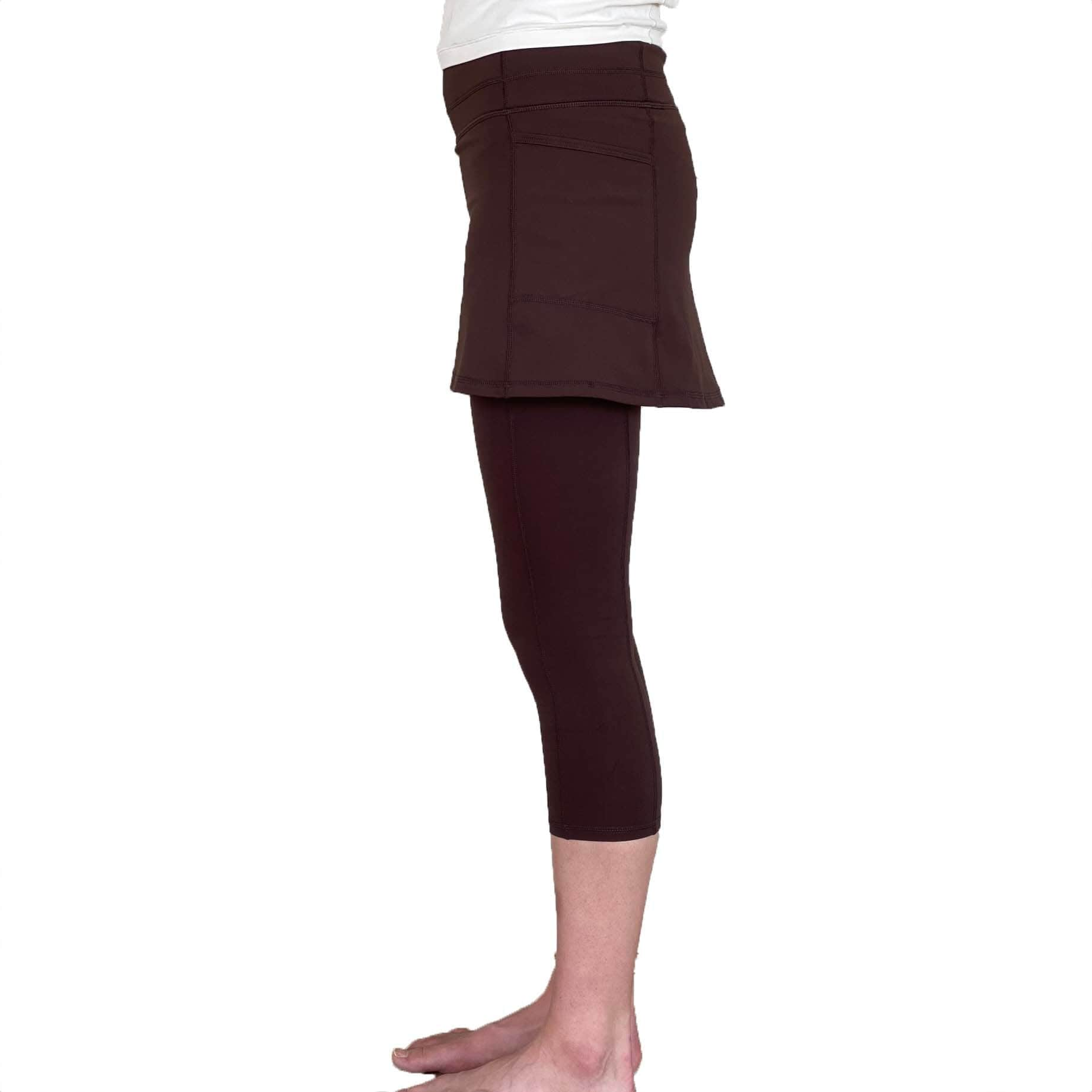 Studio shot of model from waist down wearing Espresso Brown 2-1 Skirted Ankle-Length Leggings from side